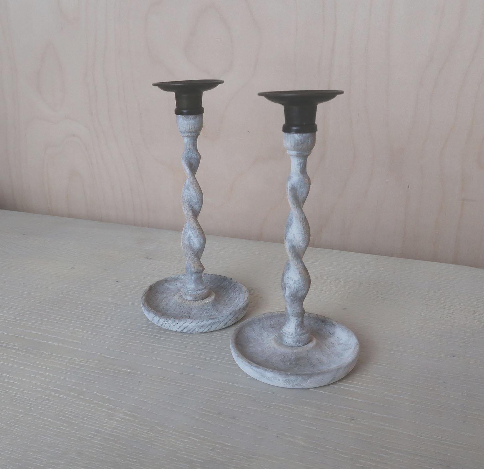 A super pair of limed oak twist candlesticks.

They have been recently limed to enhance the beautiful grain in the oak.

The brass sconces are original.


