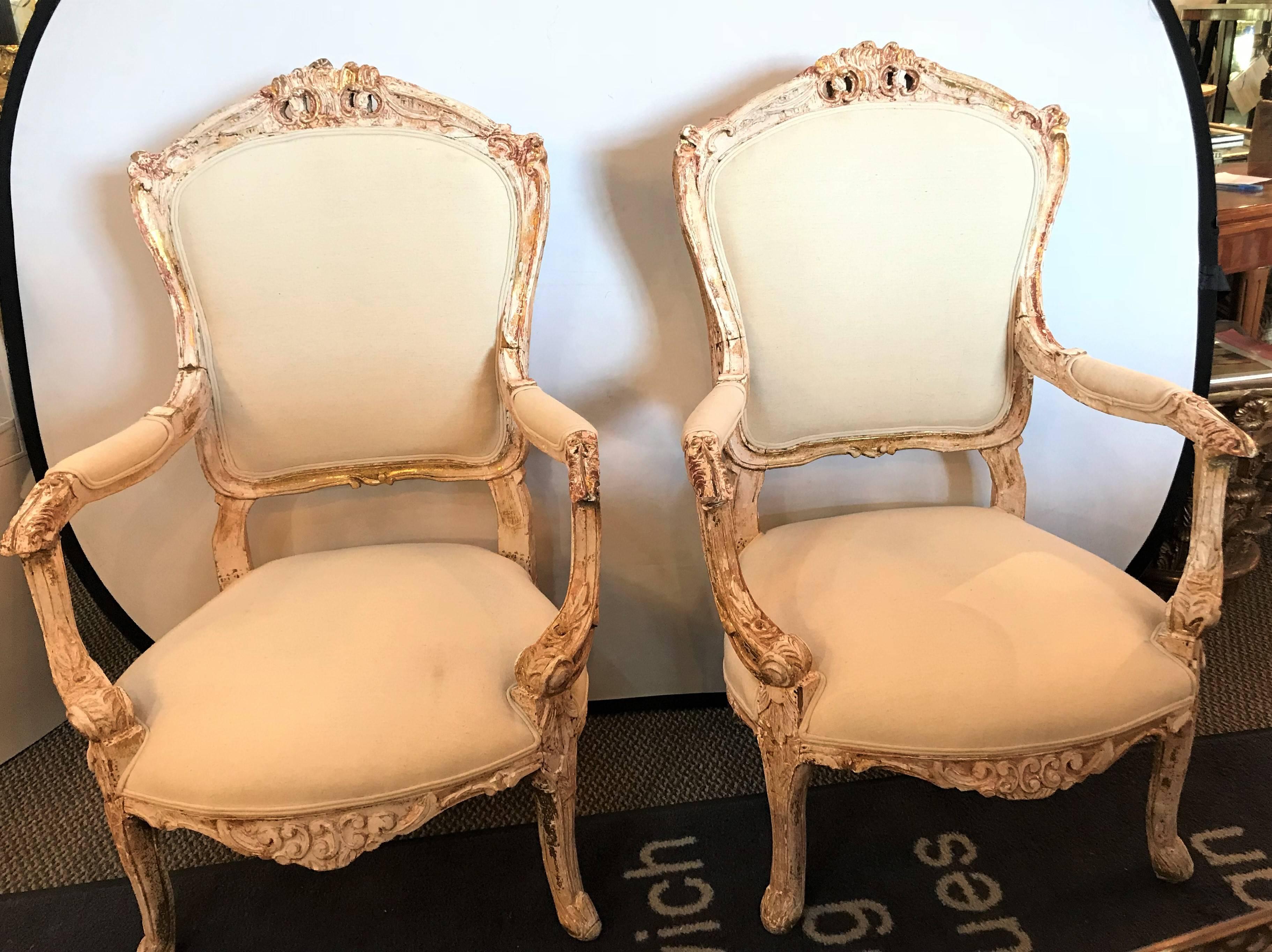 A pair of antique Louis XV style armchairs in painted distressed frames. Each having a wonderful antique frame that has been washed with new burlap upholstery. 
Lxx.
