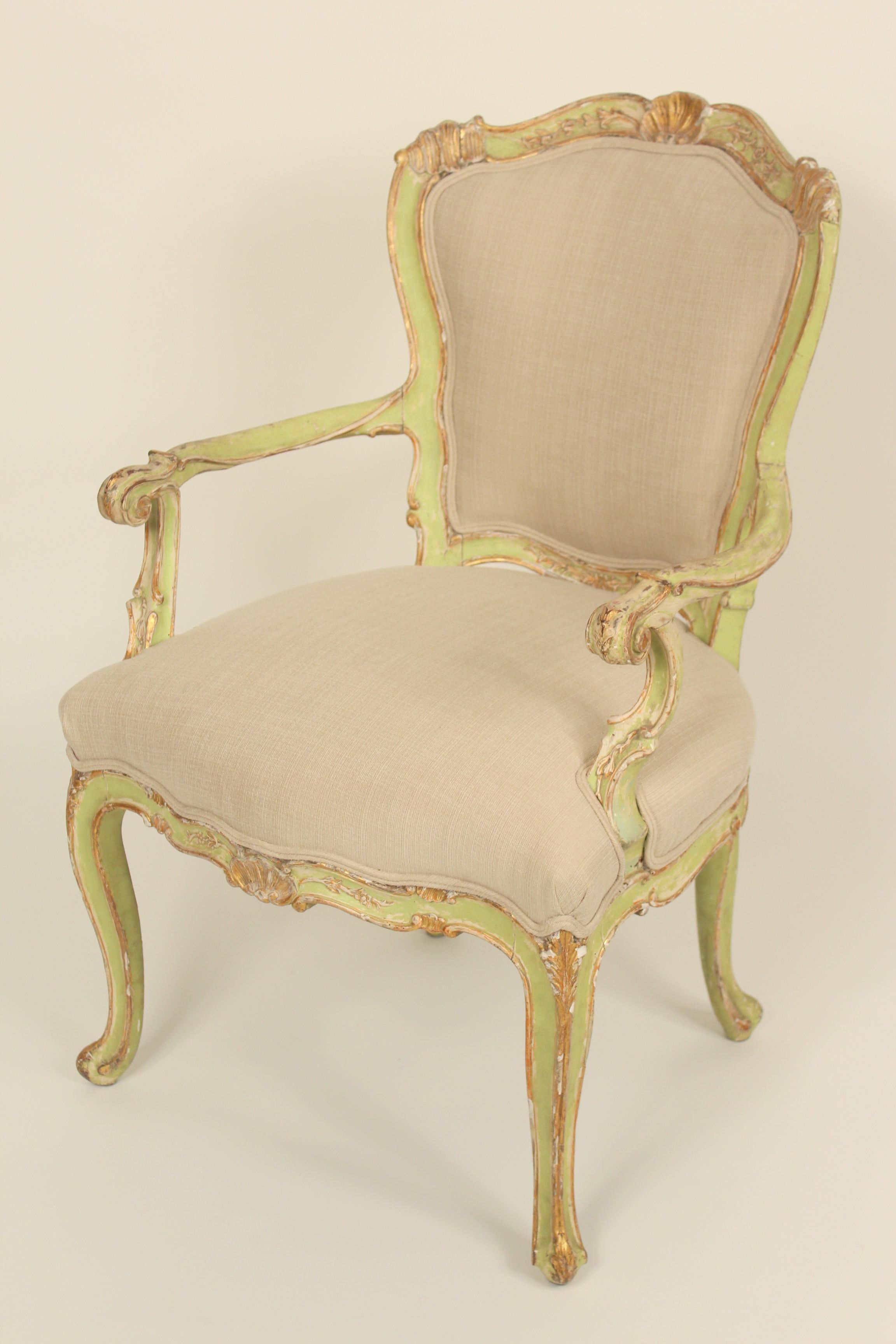 Pair of antique Louis XV style painted and gilt decorated armchairs, late 19th century. Nice old original paint and gilt decoration. The upholstery on these chairs is new.