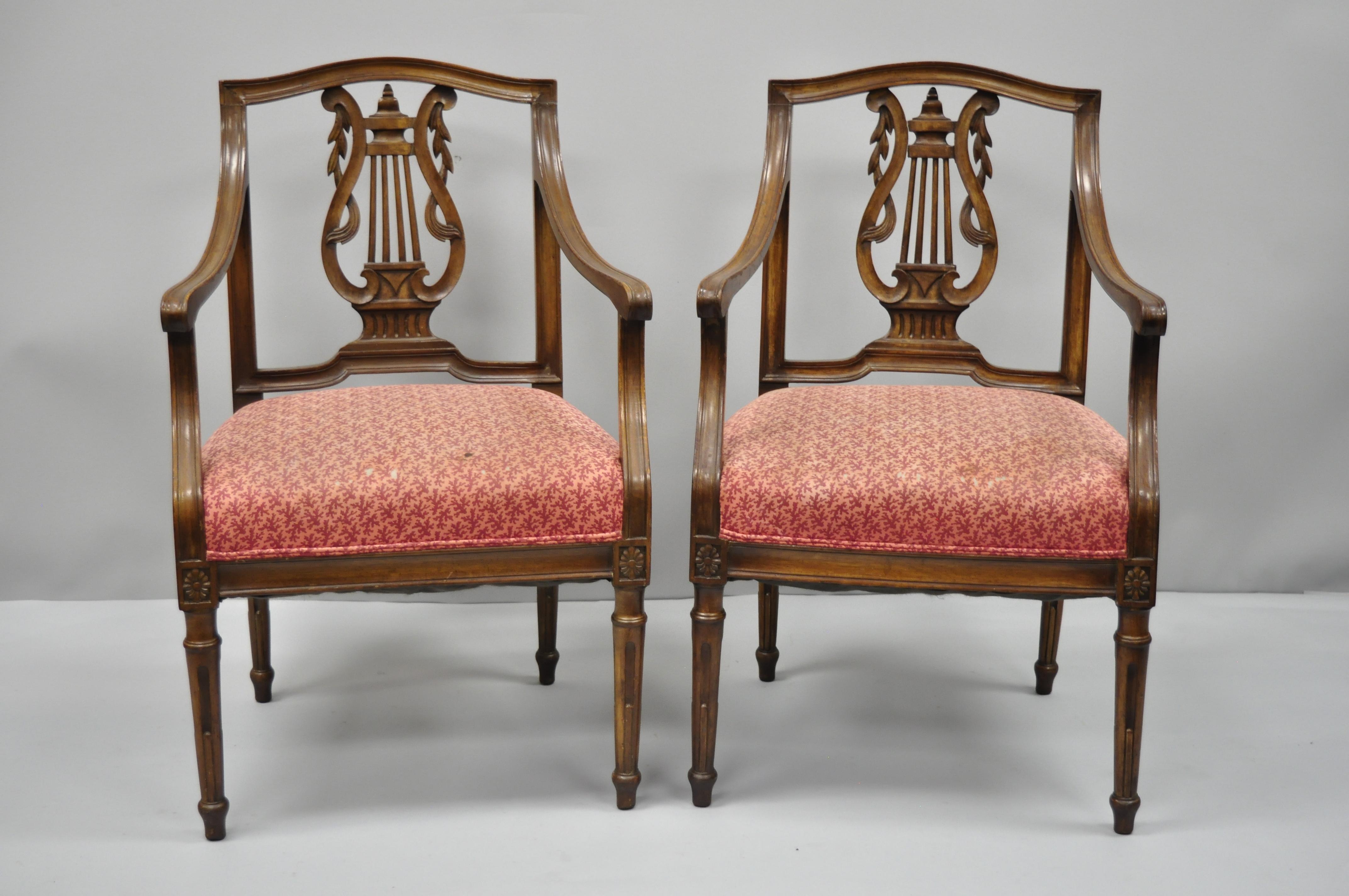 Pair of antique Louis XVI French style lyre back Italian armchairs. Items feature carved lyre backs, smaller attractive frames, solid wood construction, tapered legs, great style and form, circa early 20th century. Measurements: 34.5