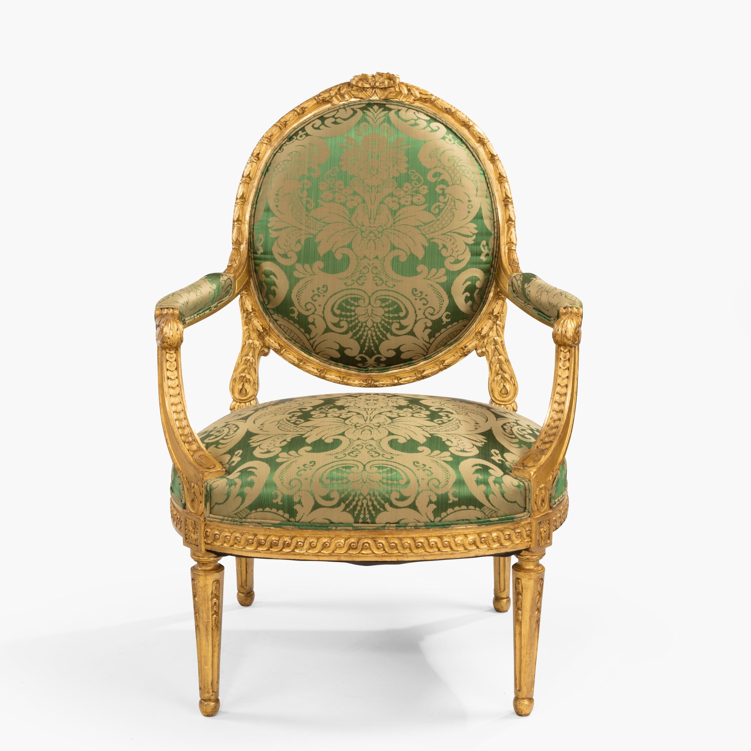 A Good Pair of Fauteuils en Cabriolet in the Louis XVI Manner

Constructed in giltwood with extensive carving; rising from turned and tapering channelled legs, the curved seat rails dressed with carved Vitruvian scrolls with upholstered seats, the