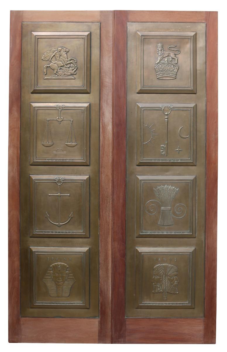A pair of superb quality Mahogany doors, inset with cast bronze panels to the front side. The reverse having a raised and fielded, four panel arrangement.

Probably a unique commission for a city of London building.

Symbol meanings:

George