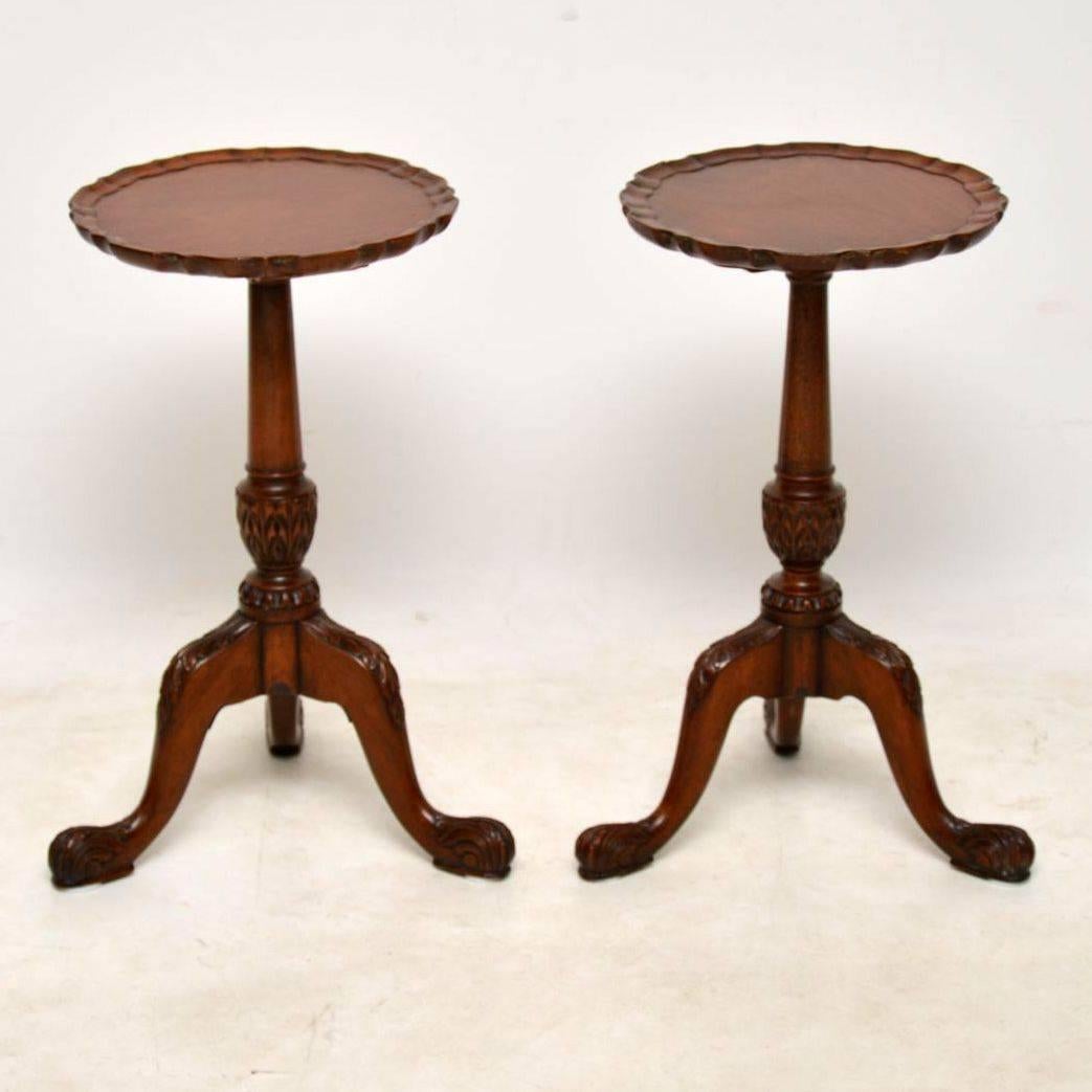 Pair of antique mahogany wine tables of extremely high quality, dating from circa 1910 period. The tops have pie crust edges and sit on turned carved columns. The tripod legs are also carved and on the feet. These tables are strong looking in good