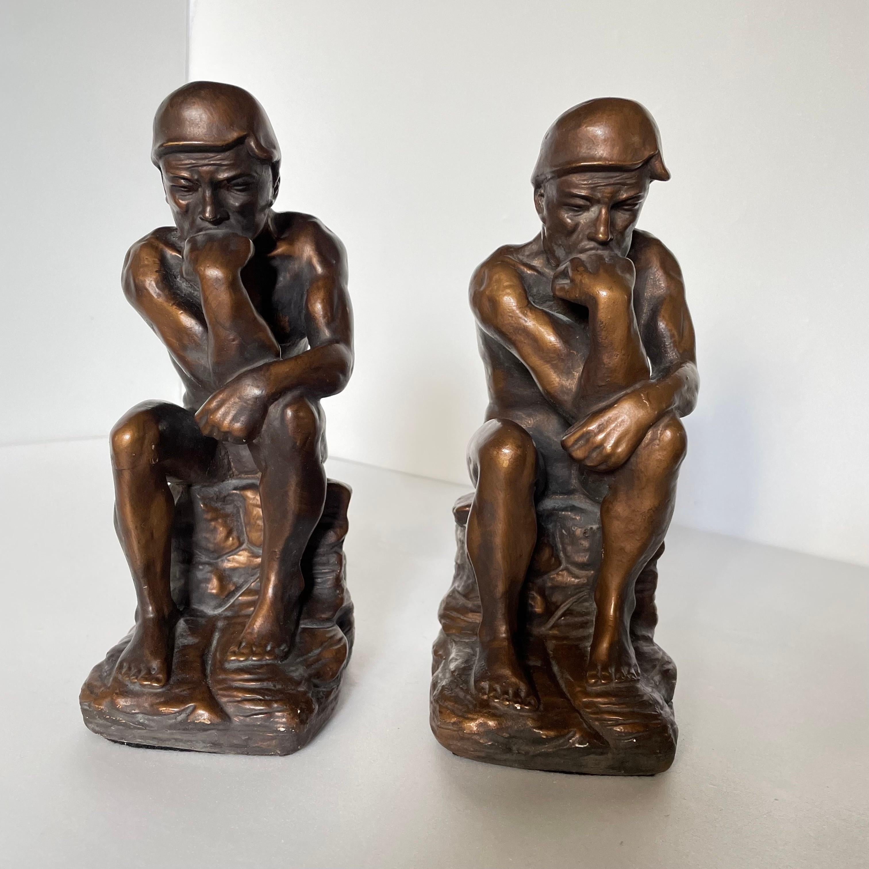 Pair of vintage chalk ware Thinking Man bookends in a faux bronze finish. There are some minor chips on both bookends, but over all in good condition. 