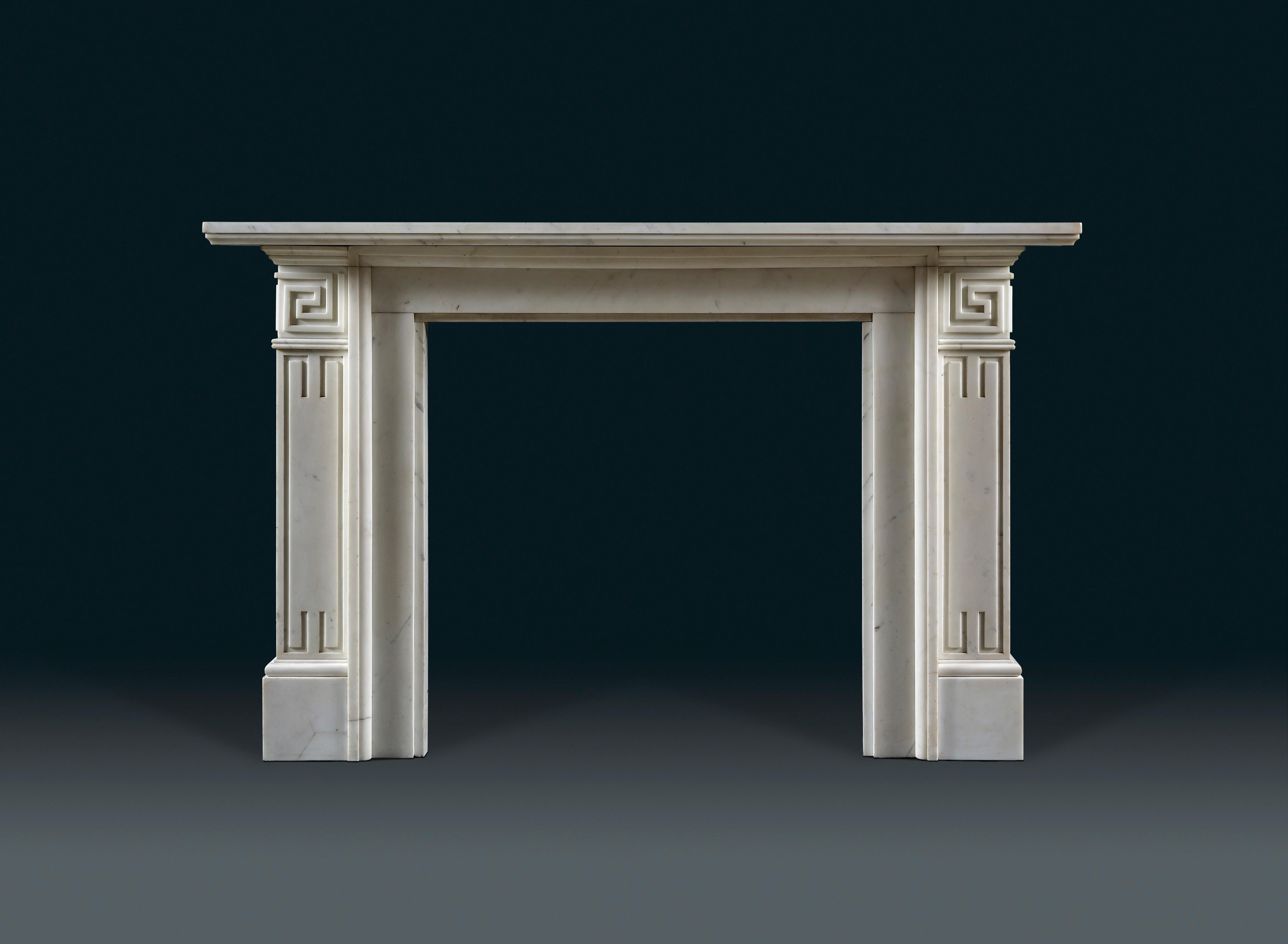 A pair of 19th century Grecian Revival chimneypieces in the manner of Thomas Hope. The end blocks and jambs incised with Greek Key detail, surmounted by a moulded shelf.