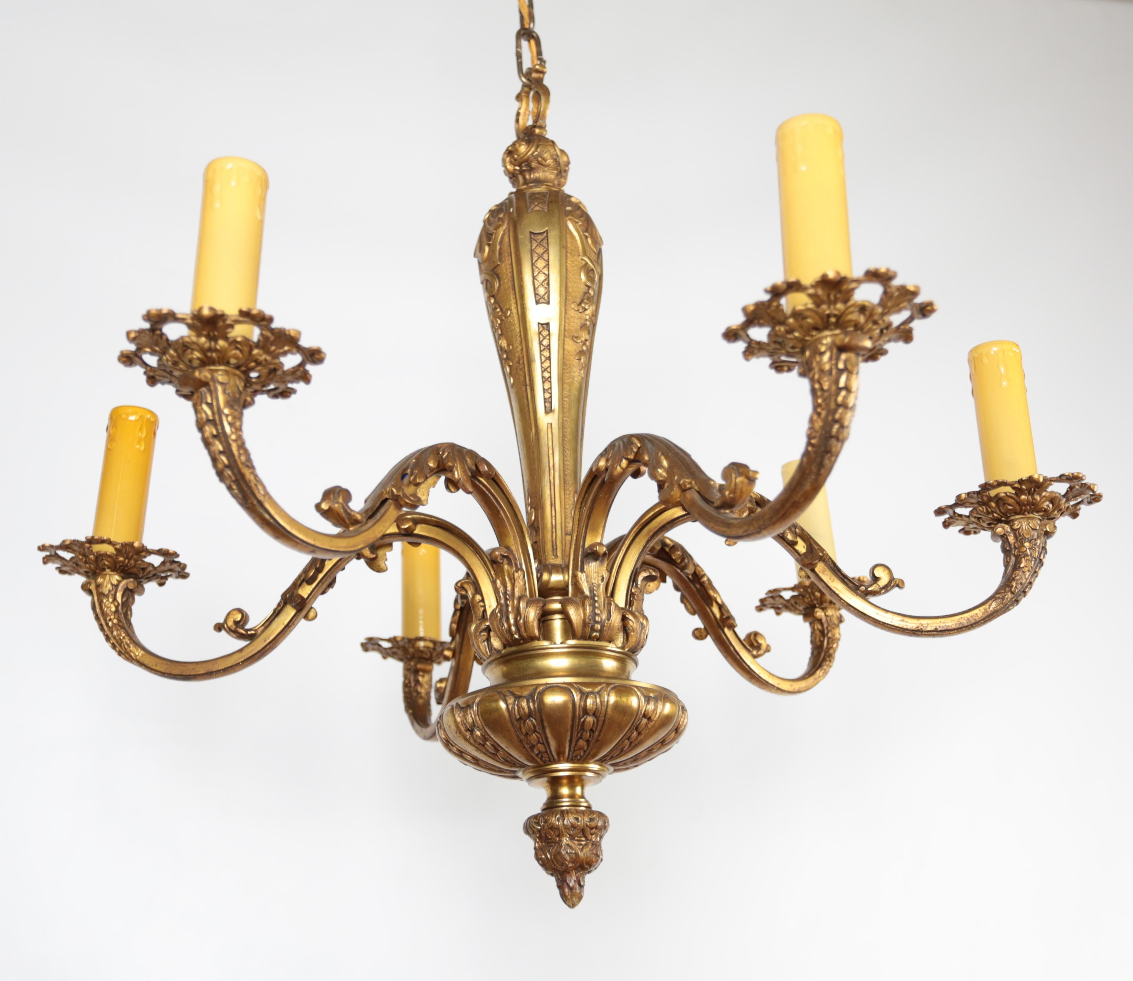 Antique Louis XIV Baroque style chandeliers made of solid cast bronze represent a majestic elegance that elevates the interior. The chandeliers are polished to a high golden shine. First-class quality of material and craftsmanship. The chandeliers