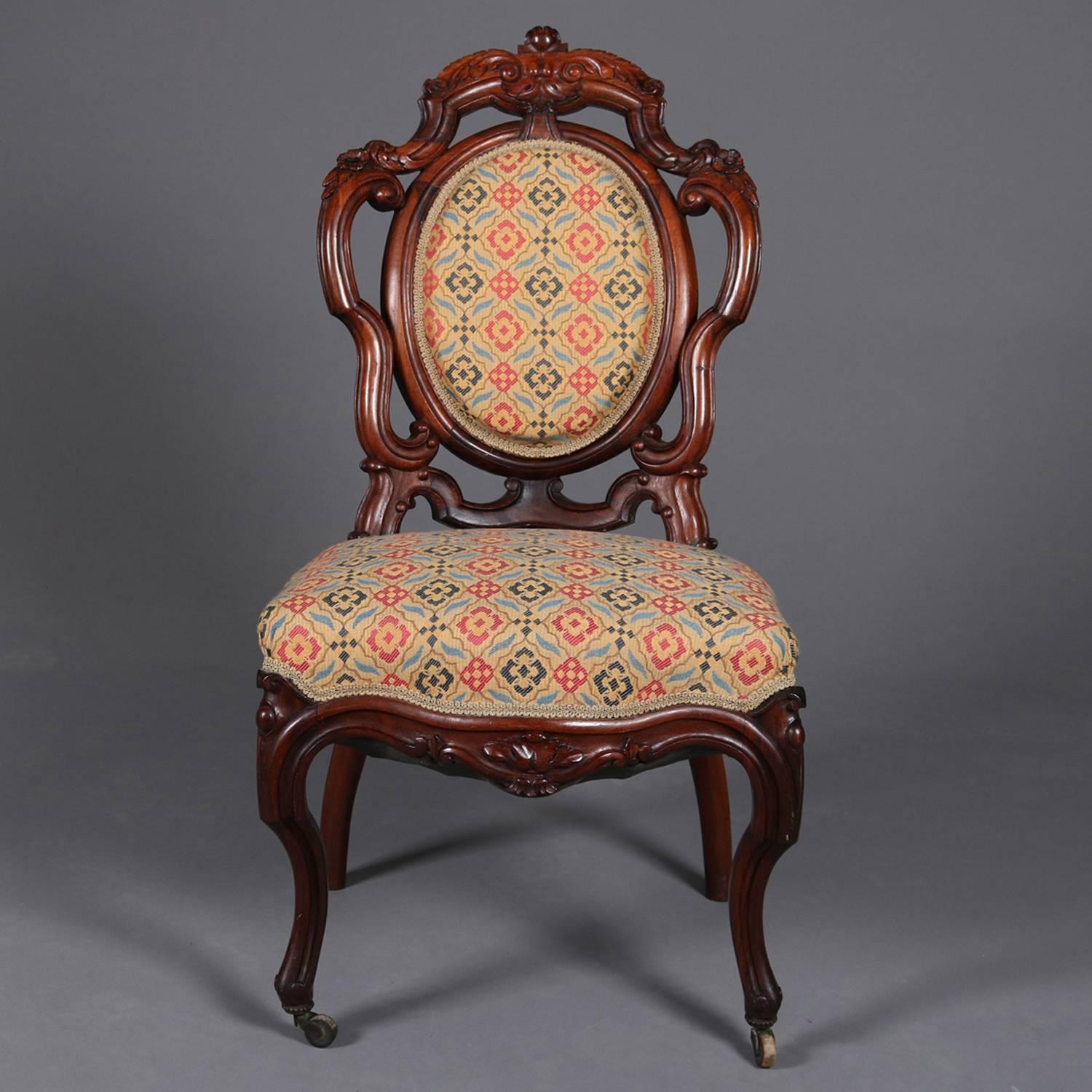 Pair of antique Meeks School side chairs feature carved and pierced scroll form rosewood frames with upholstered backs and seats, raised on cabriole legs, reminiscent of work by Henry Belter, circa 1900

Measure: 37.5