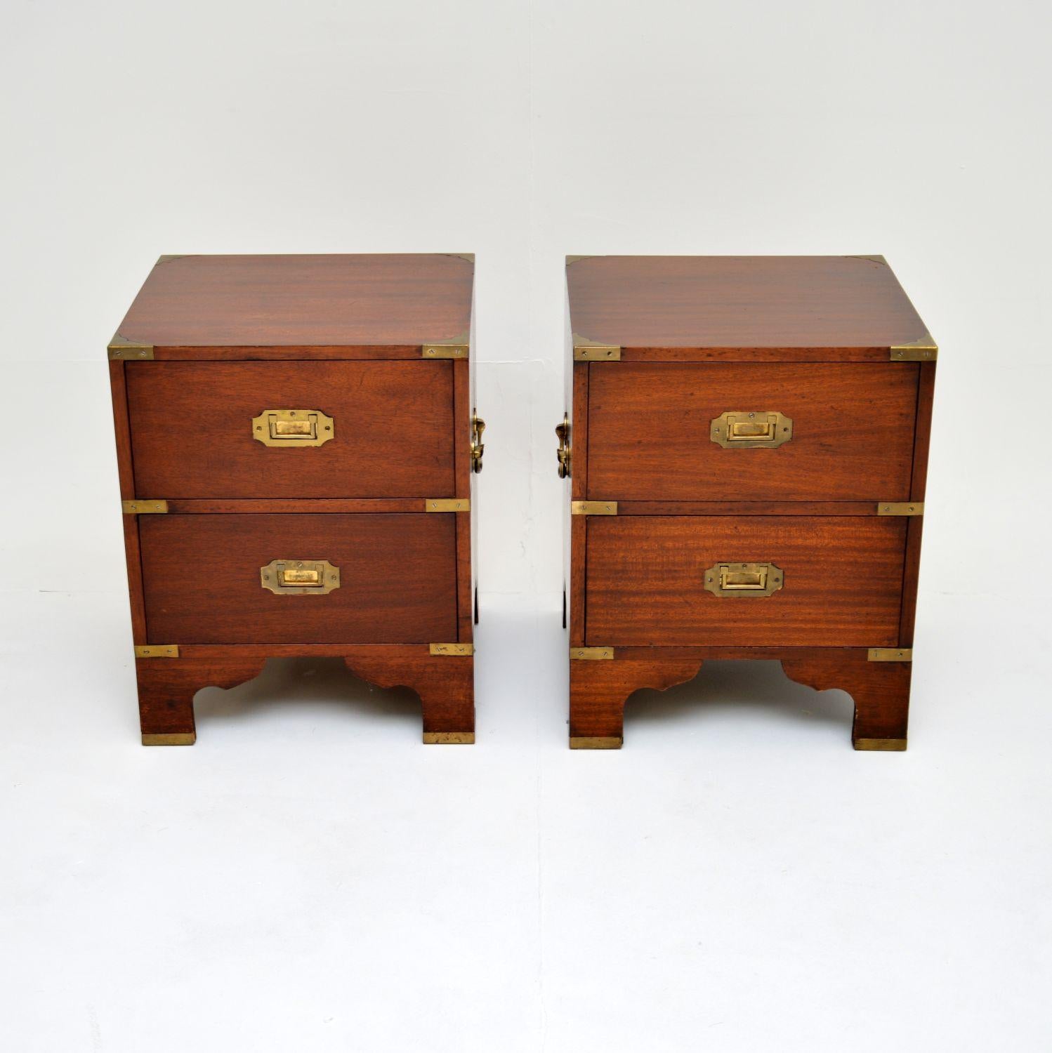 A fantastic pair of antique bedside chests in the military campaign style. They were made in England, and date from around the 1920-1930s.

They are of superb quality and are a lovely size, perfect for use as bedside chests or even as side tables