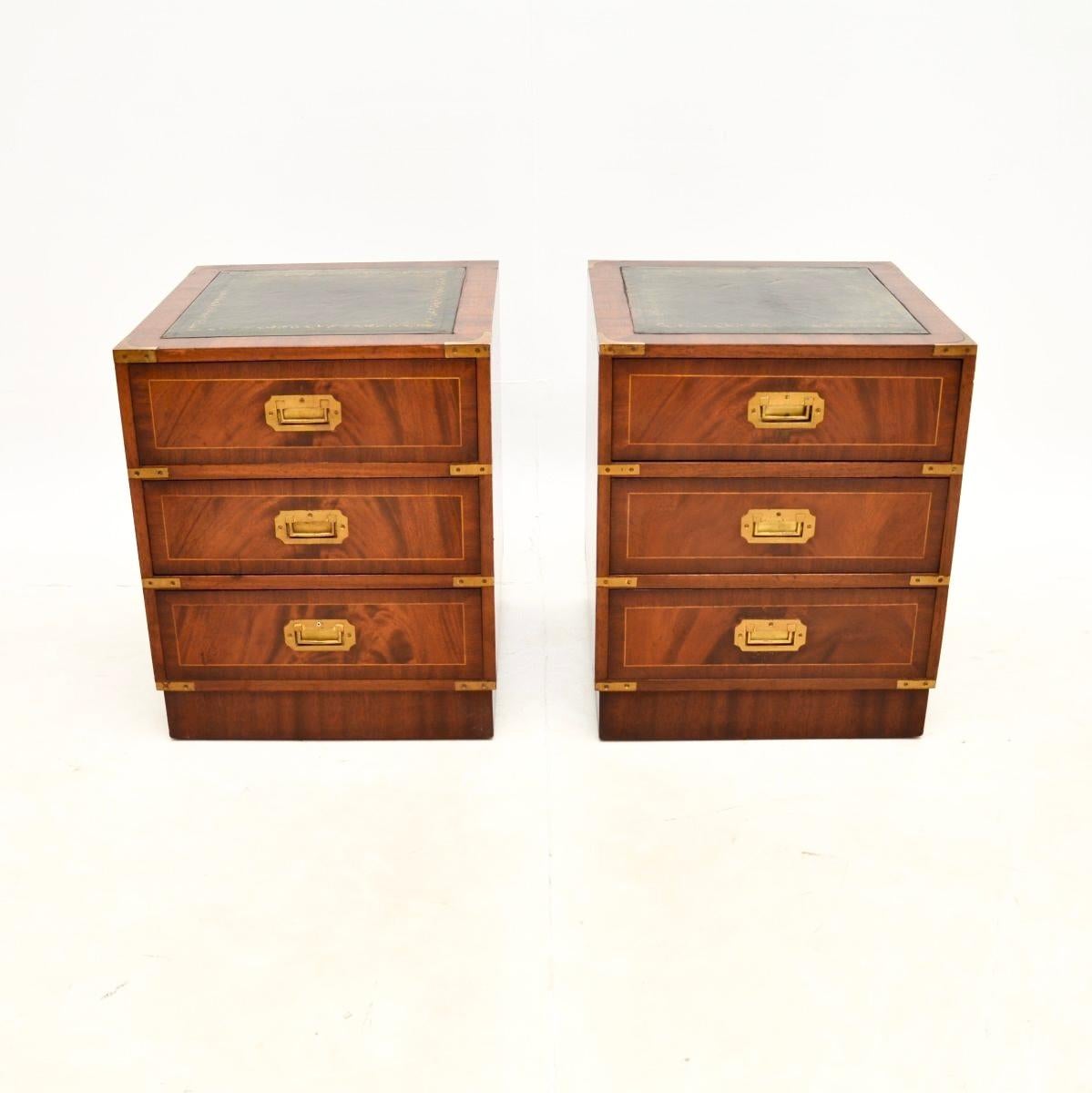 A smart and very useful pair of antique military campaign style bedside chests. They were made in England, and date from around the 1950’s.

They are of super quality and are a great size. They have inset tooled leather tops, the drawers have brass