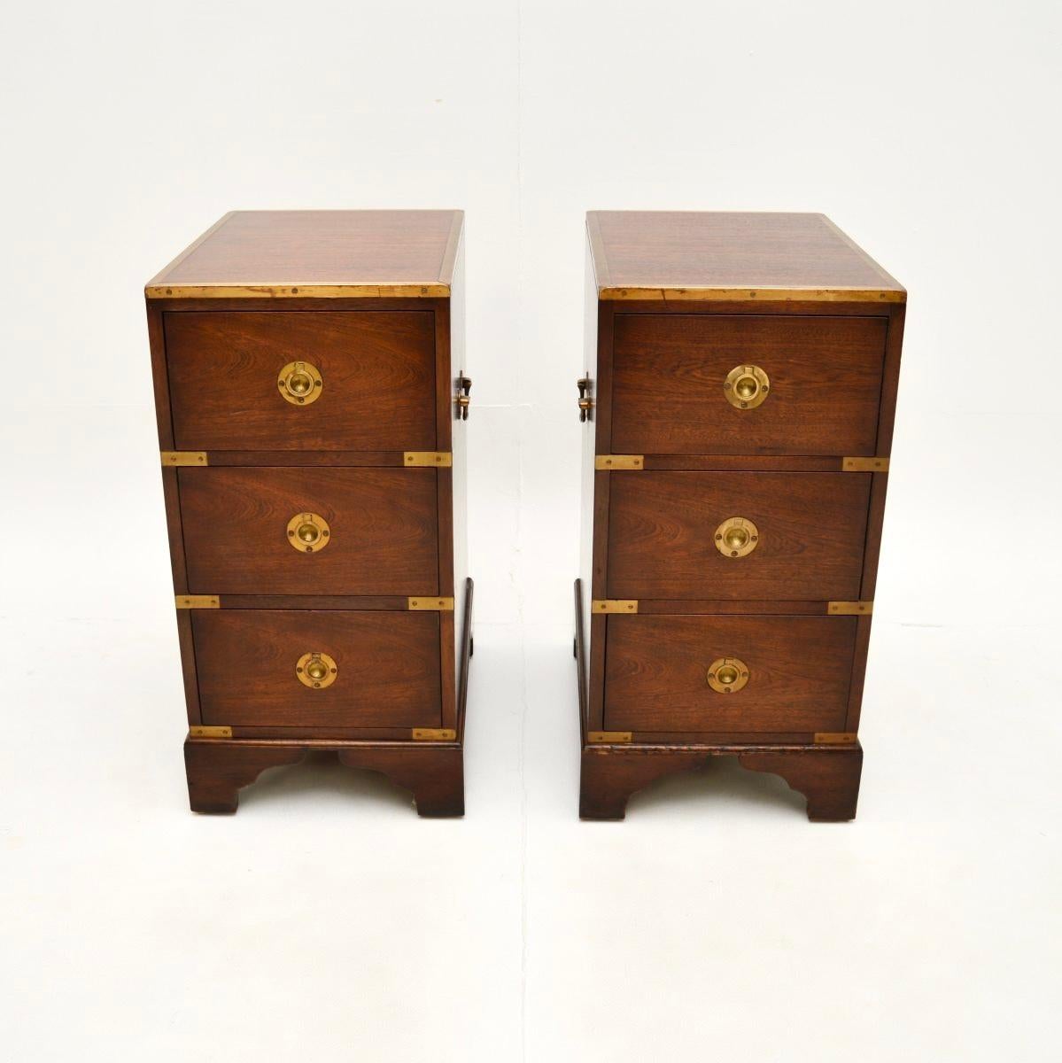 A smart and very well made pair of antique military campaign style bedside chests. They were made in England, and date from around the 1930’s.

The quality is outstanding, they are beautifully designed and are a great size. The wood has a gorgeous