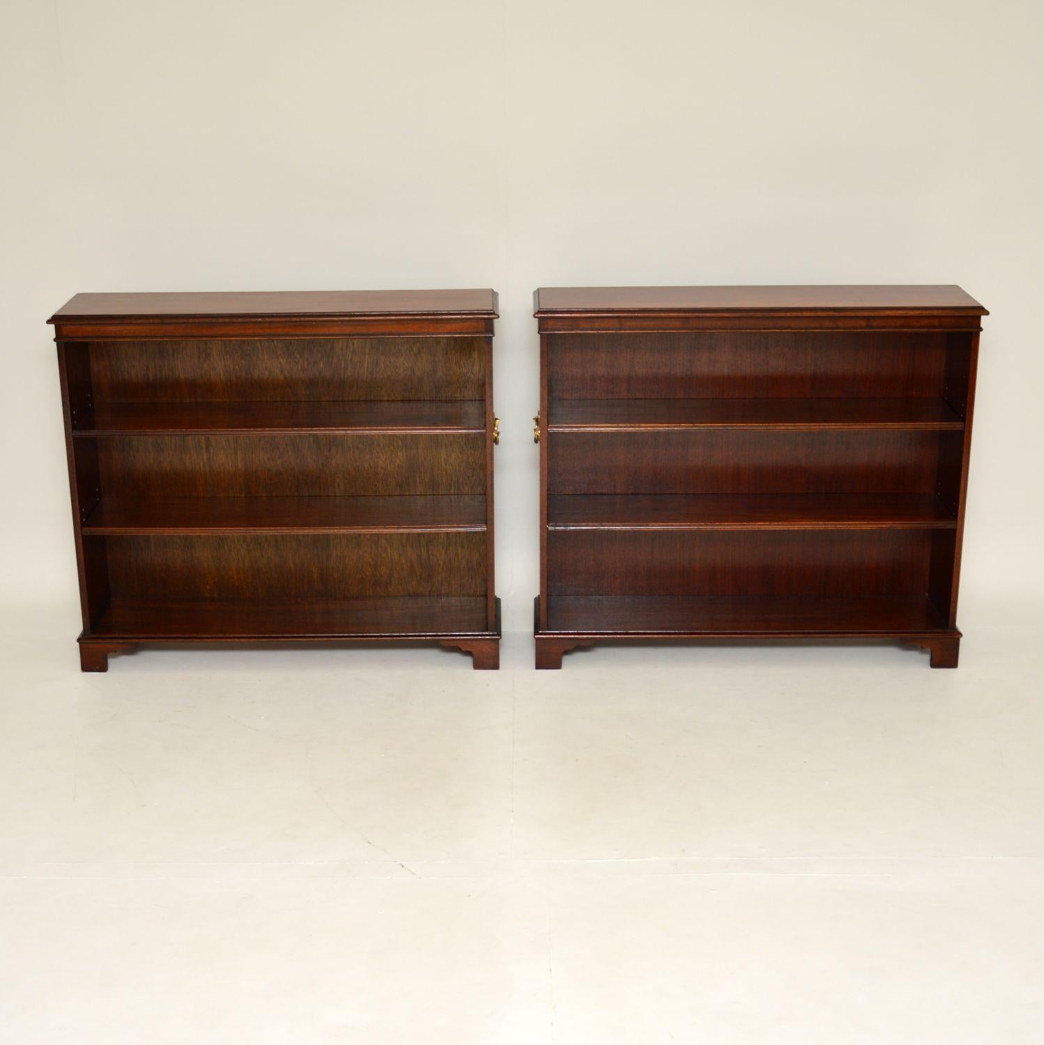 A smart and very stylish pair of antique open bookcases. These were made in England & I would date them from around the 1930-50’s period.

They have a simple yet very handsome design, with a wood construction and brass military style carrying