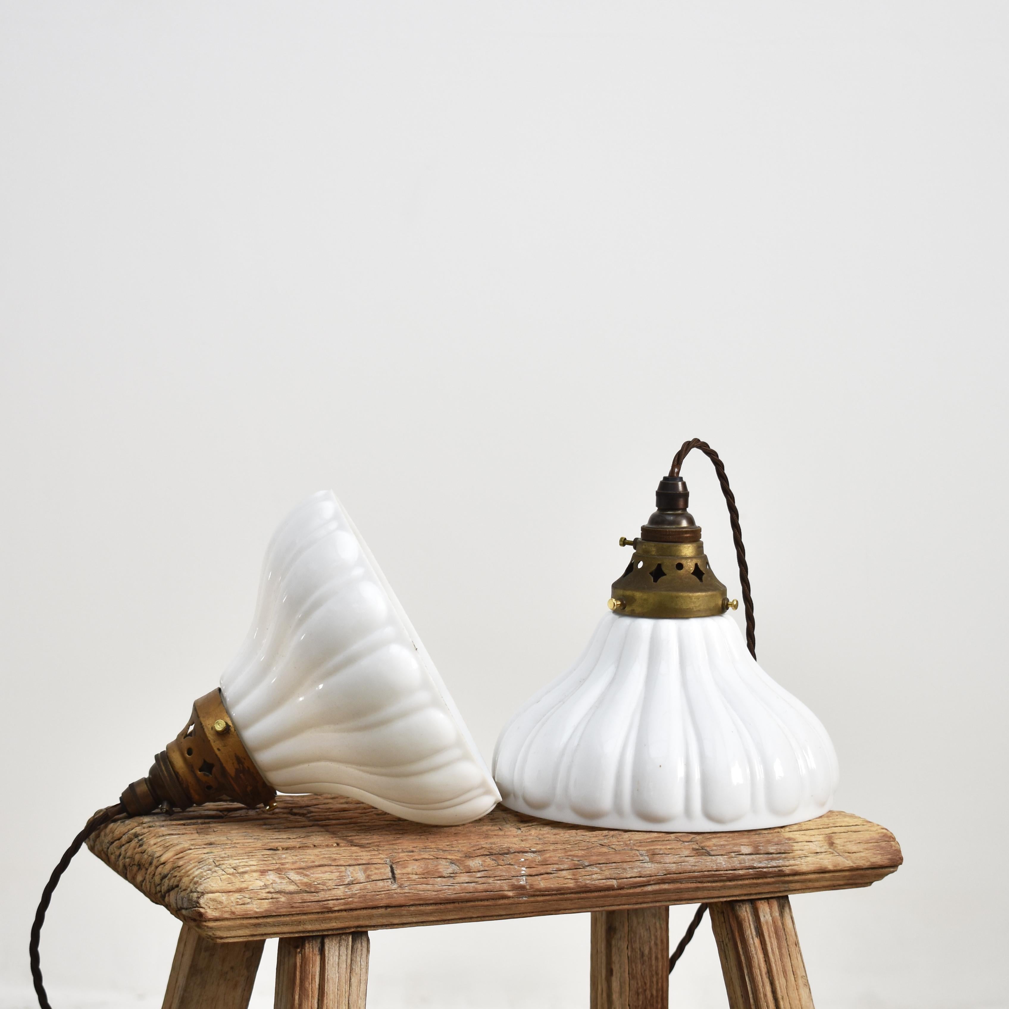 Pair Of Antique Milk Glass Holophane Pendant Lights – D

A pair of antique pendant milk glass lights salvaged from a chapel. The lights have retained their original brass galleries manufactured by ‘Holophane’. The shapely milk glass shades look