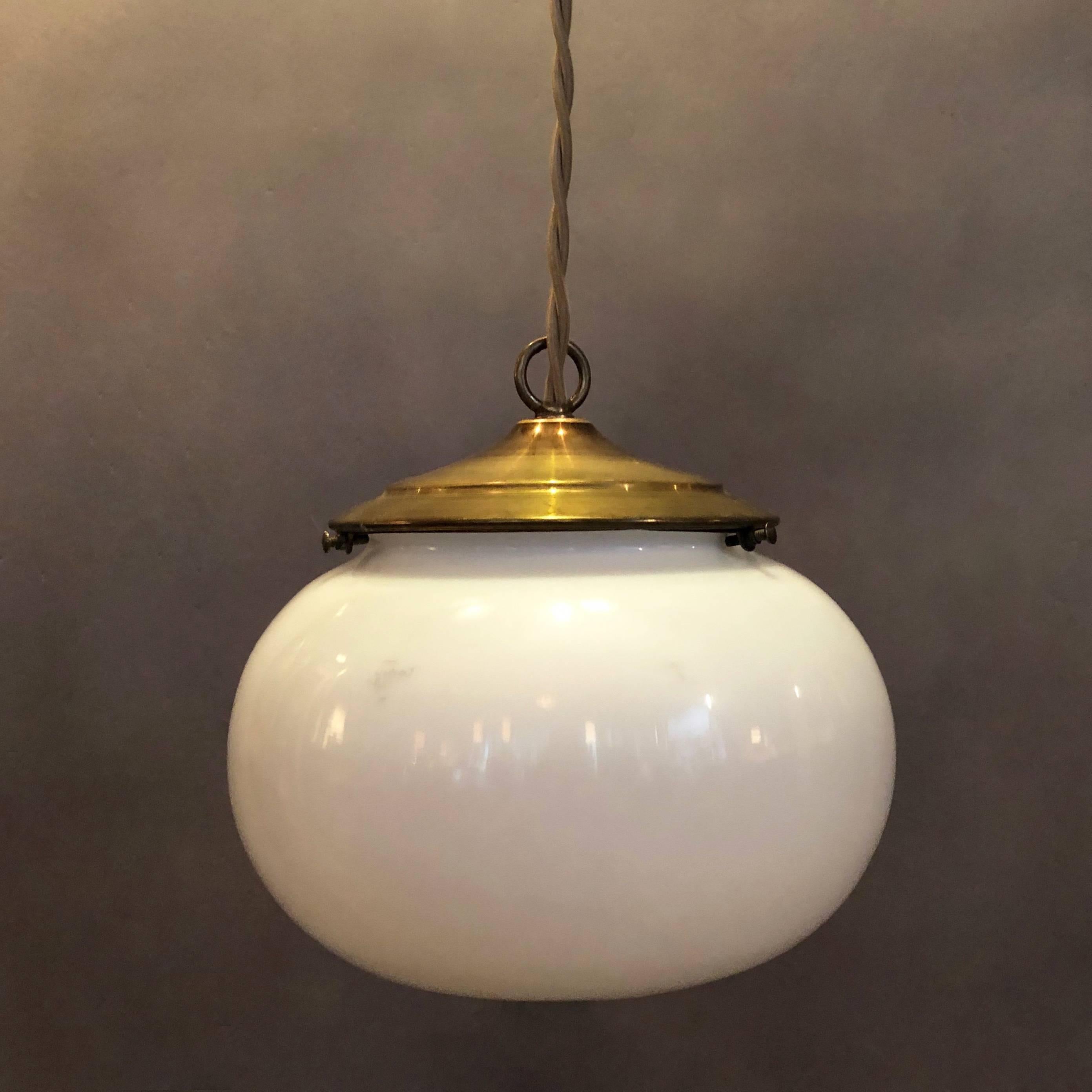 American Pair of Antique Milk Glass Open Orb Brass Pendant Lights
