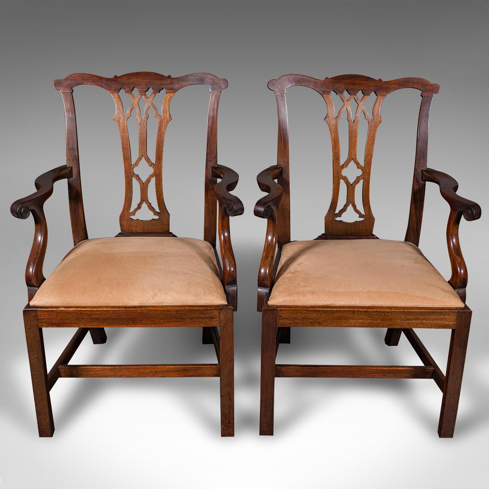 
This is a pair of antique morning room elbow chairs. An English, mahogany carver seat in Chippendale revival taste, dating to the late Victorian period, circa 1890.

Superb Chippendale revival taste and fine craftsmanship
Displaying a desirable