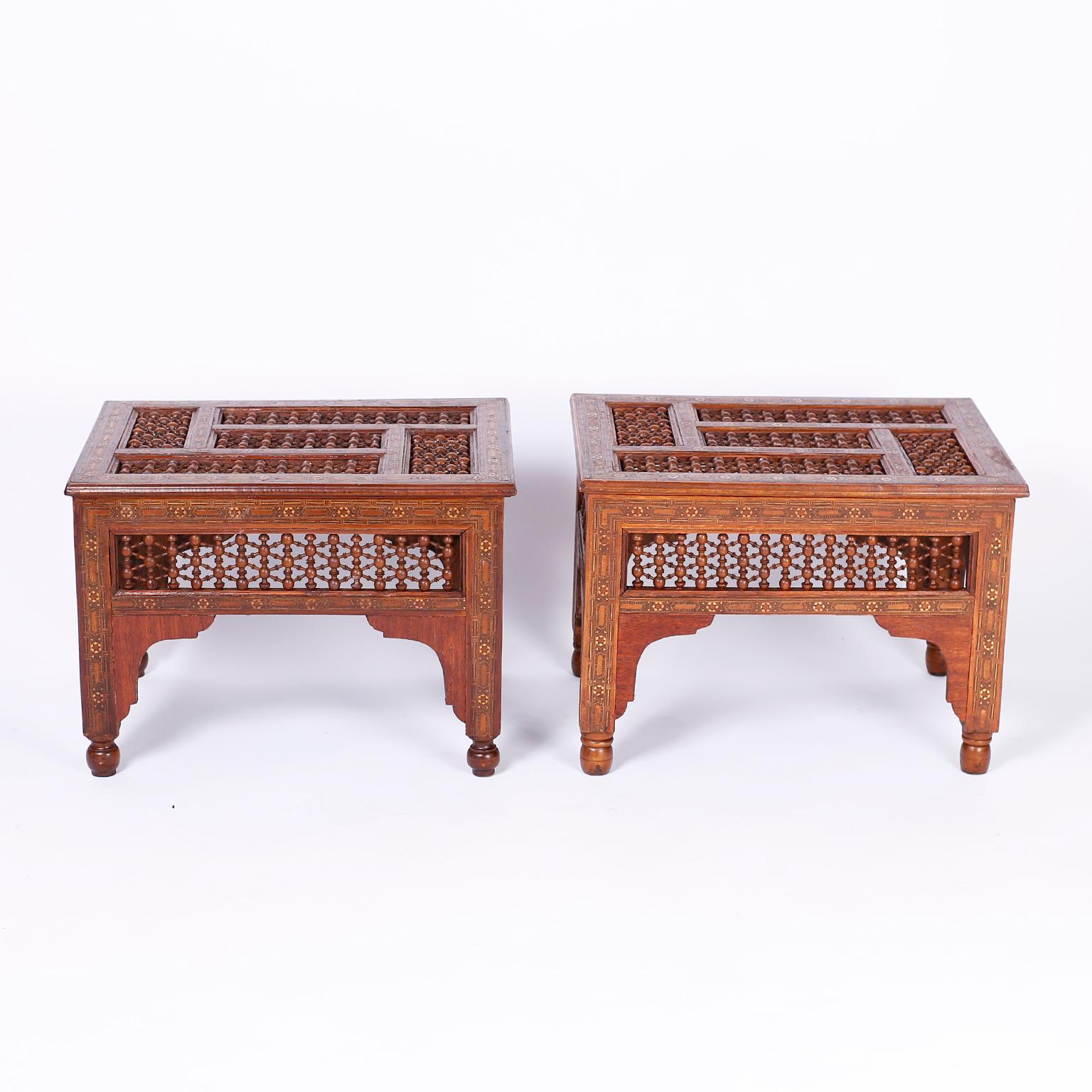 Pair of antique mahogany stands with inlaid bone and exotic hardwoods in geometric designs, stick and ball panels on the top and sides, and four legs with turned feet separated by Moorish arches.