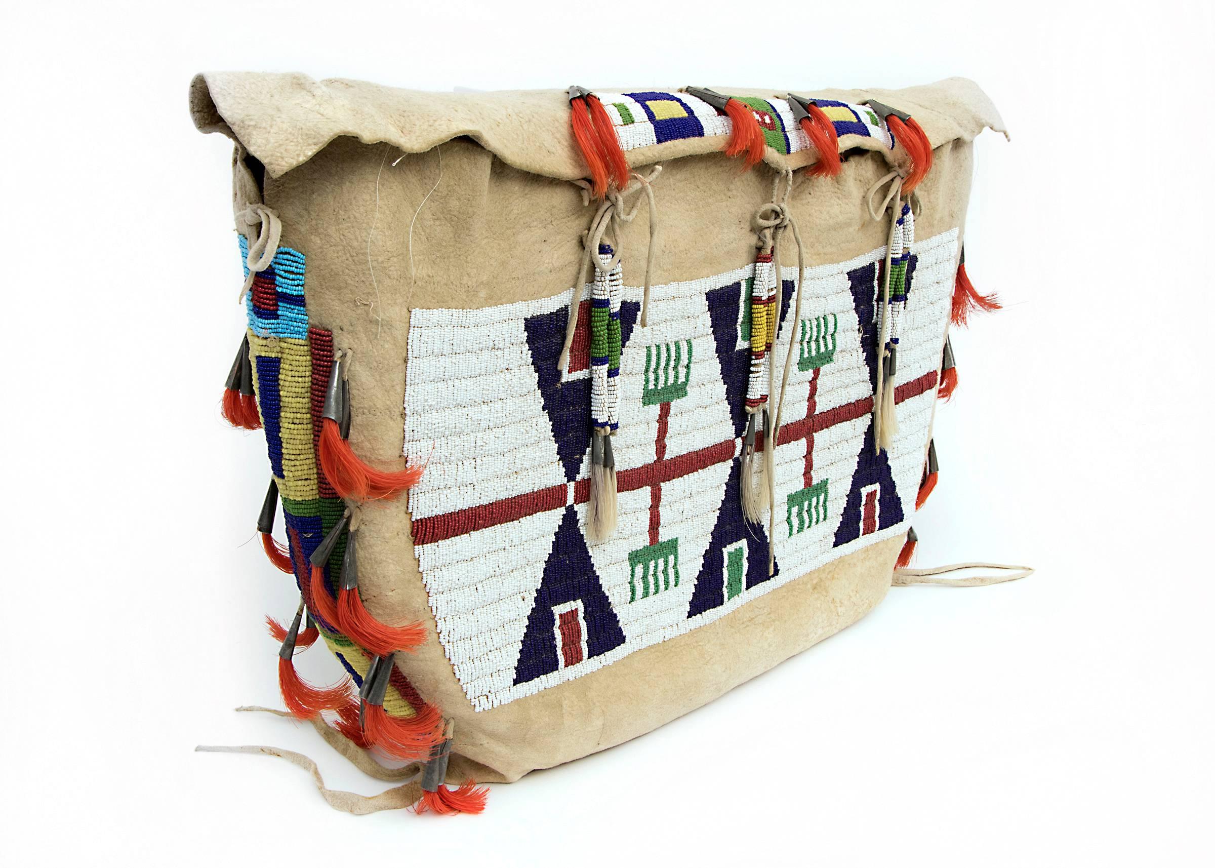 A pair of Sioux (Plains Indian) beaded possible bags (also referred to as tipi bags). Constructed of native tanned hide with glass trade beads, horse hair and tin-cone tinklers. Each Bag measures approximately 13 ½ x 24 inches. These make excellent
