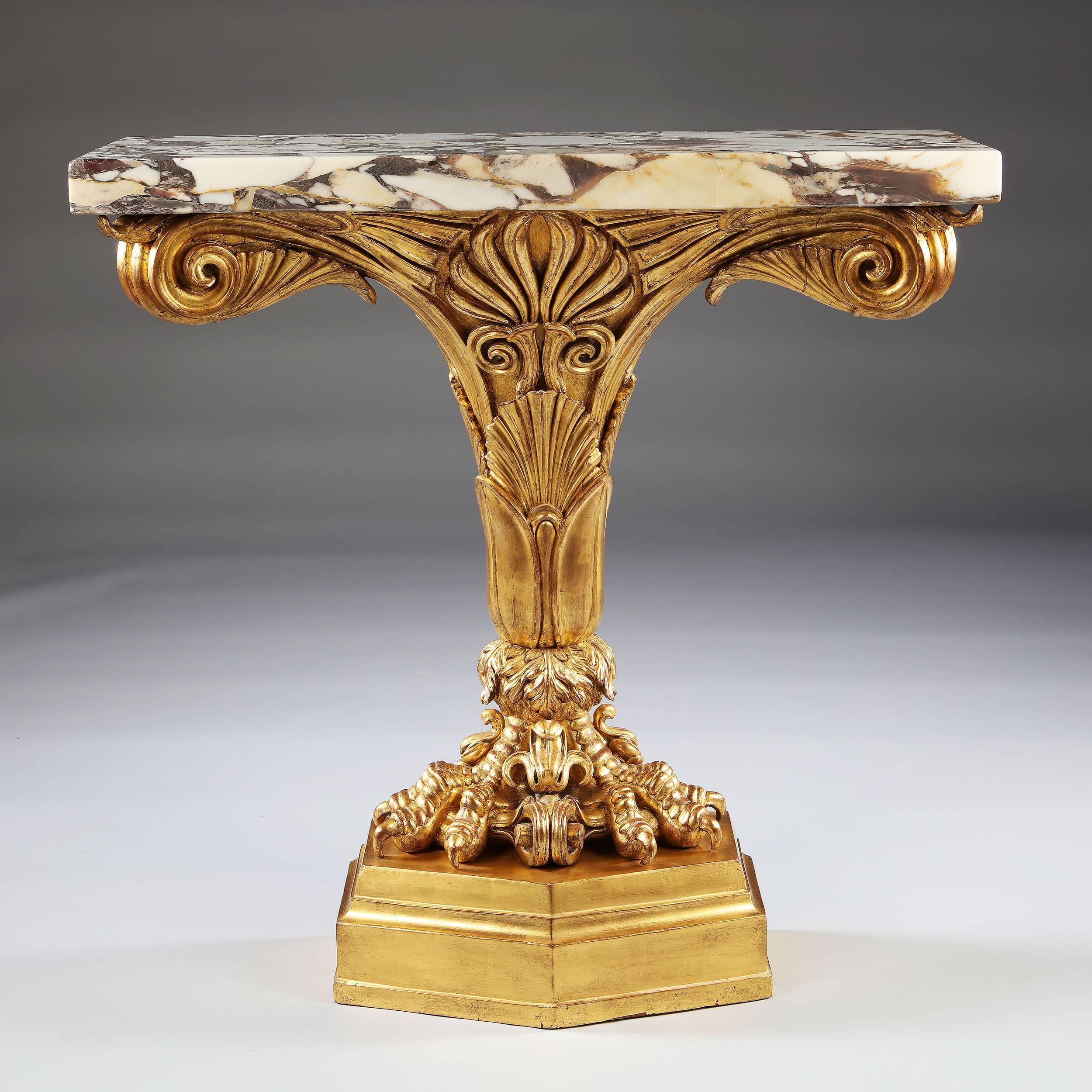 A fine pair of early 19th-century water gilt monopodia console tables, richly carved with strong vivid ornament of bold anthemions, substantial scrolled tops and supported on pierced claw feet, throughout showing great skill and attention to detail.