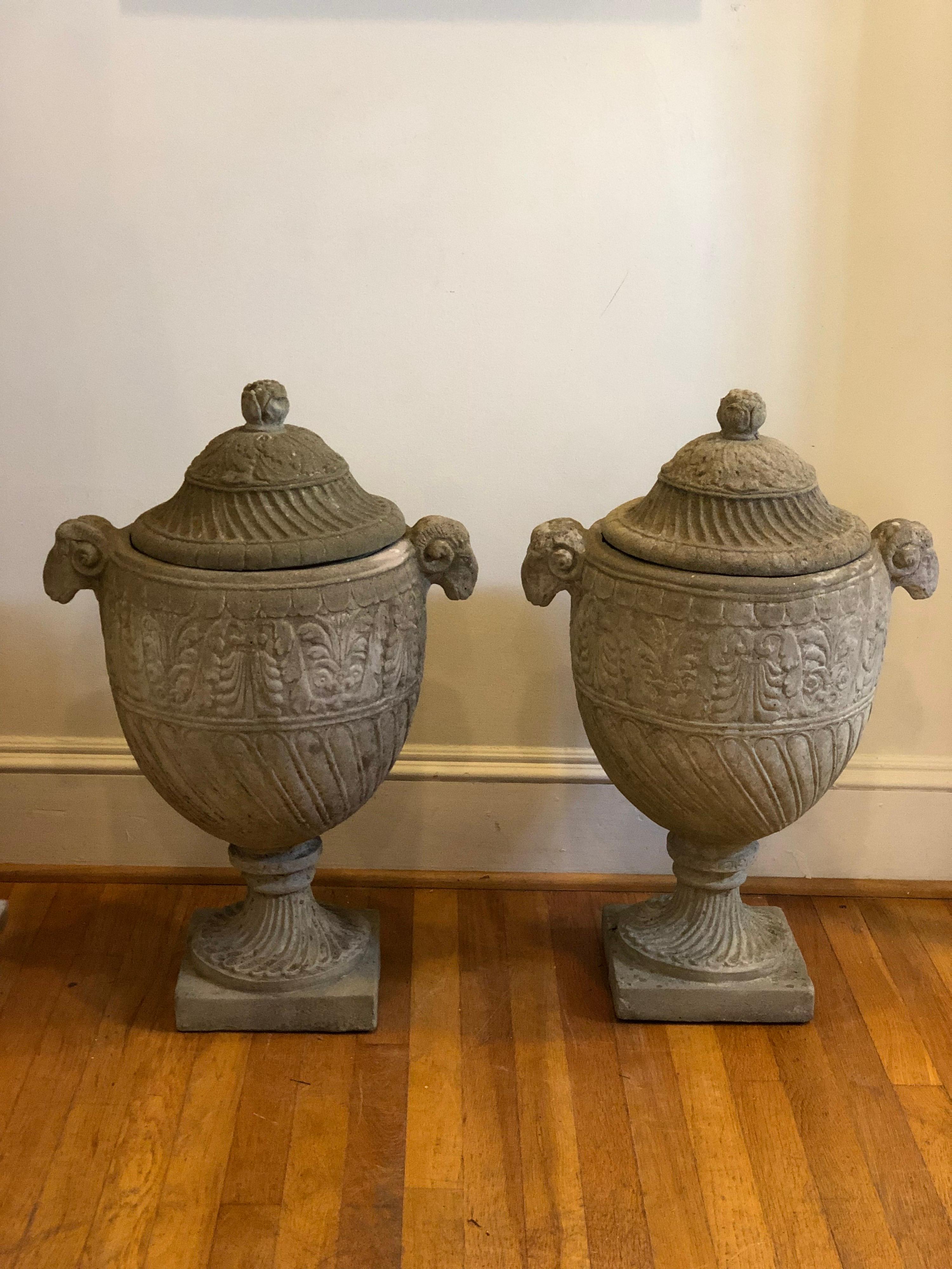 Pair of Neoclassical garden or mantel Ram Urns in natural stone with lids.
Natural patina over the years giving beautiful character. 

Please see pics for condition.