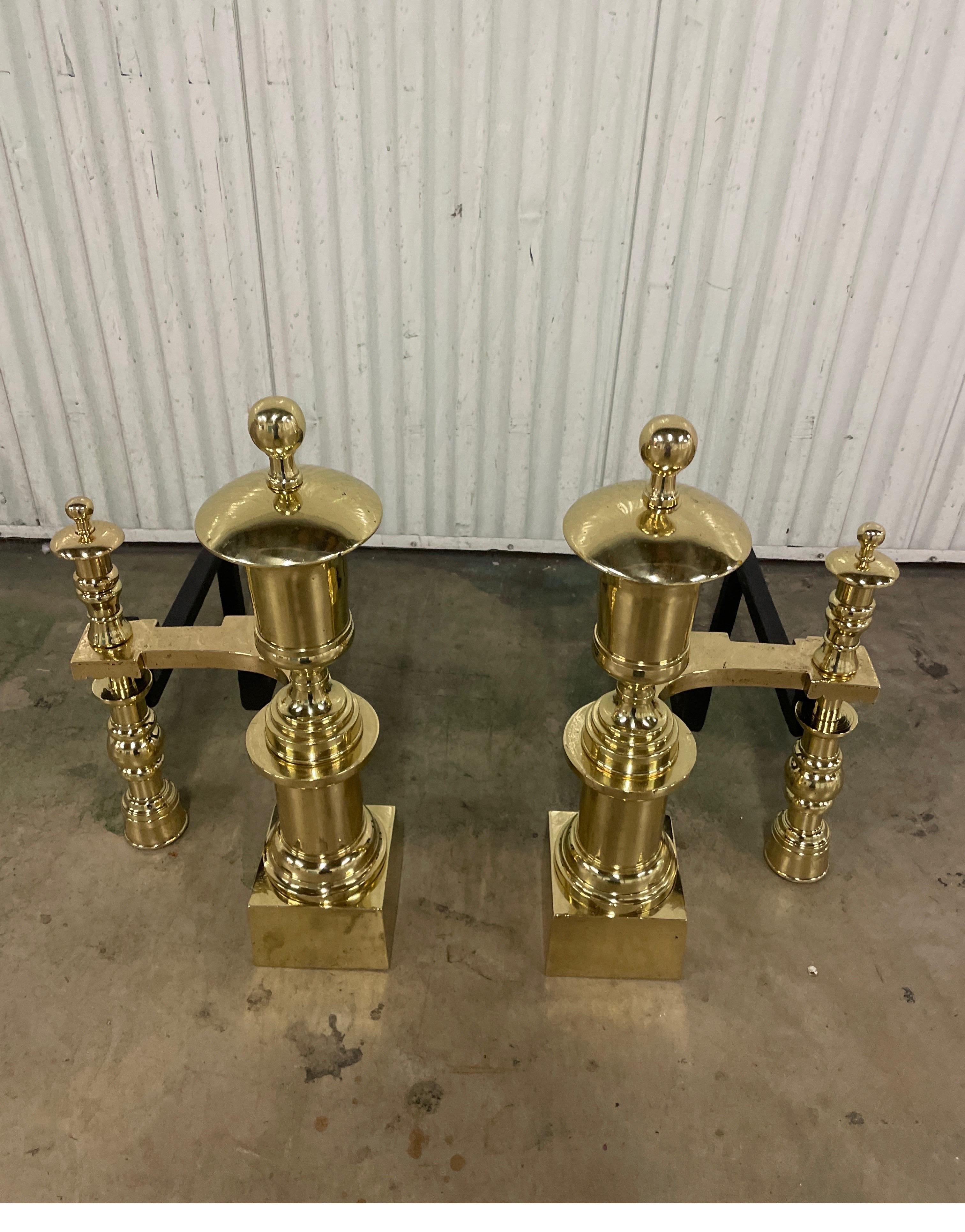 Outstanding pair of antique solid brass andirons. Very imposing solid brass Neoclassical andirons which will make any fireplace standout.