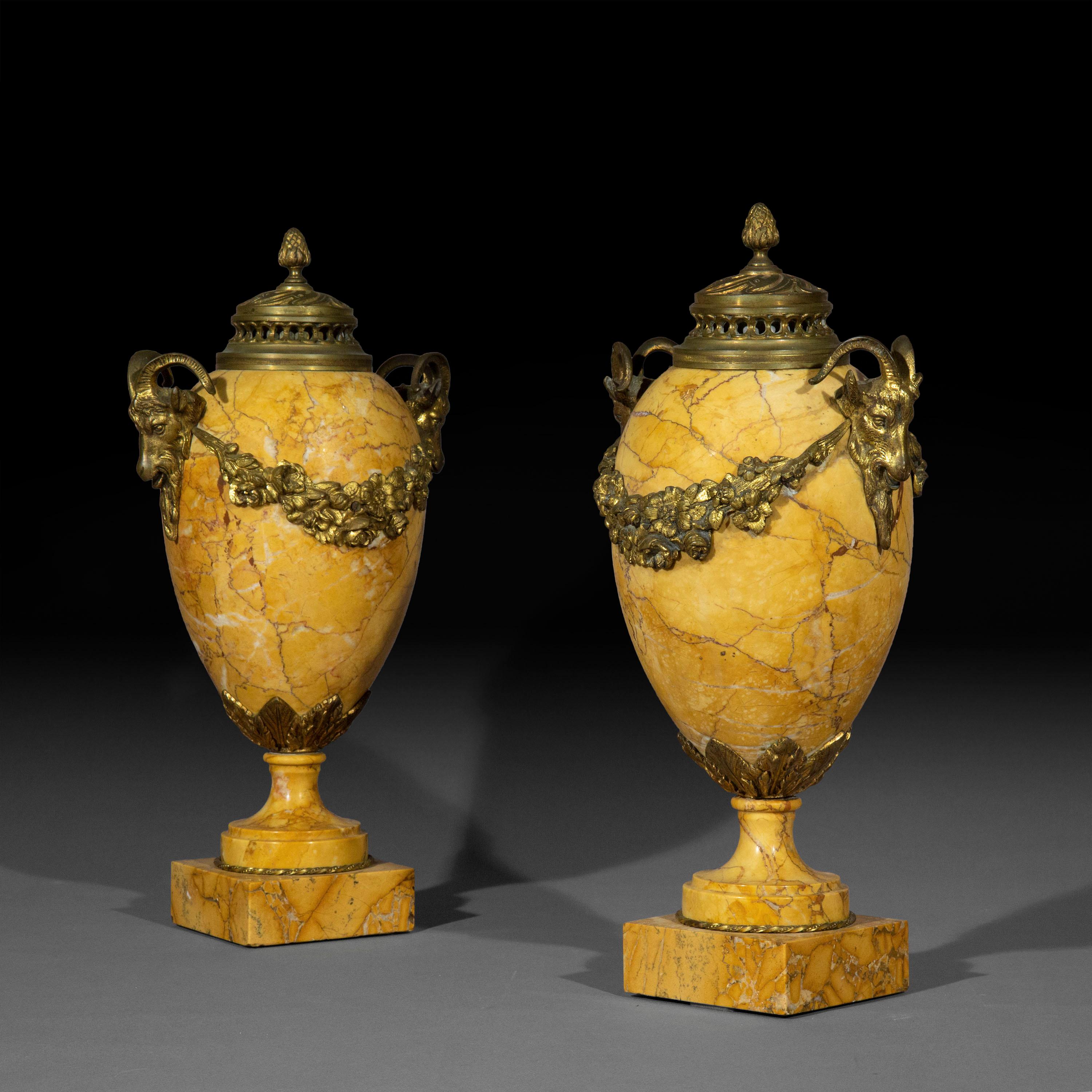 A superbly decorative pair of neoclassical Siena marble urns, with old patinated gilt bronze mounts

French, late 19th - early 20th century.

We love the colour and scale of these splendid urns. Can be converted to table lamps.
 