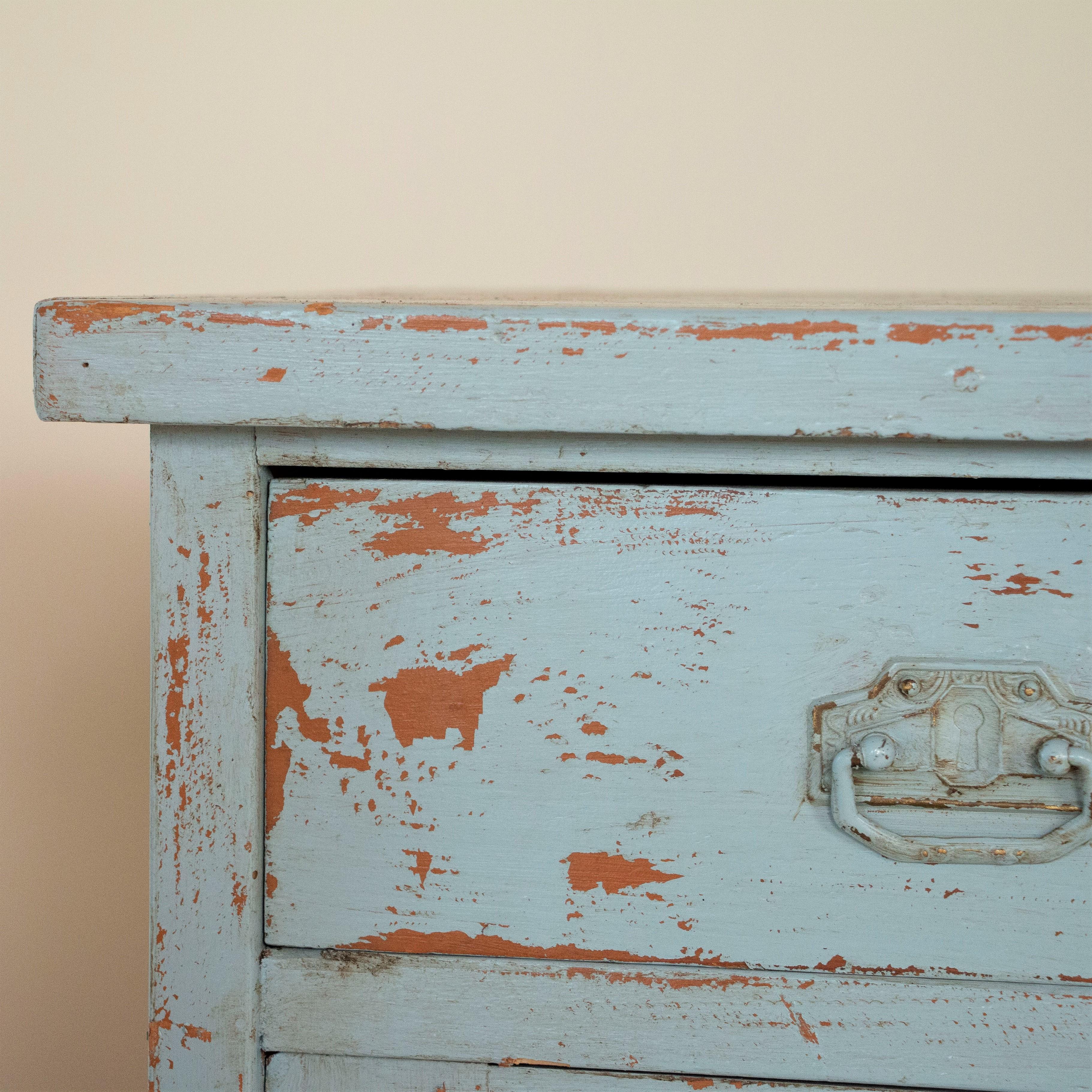 Fun and a bit funky, this delightful pair of nightstands still maintain their original blue paint. Where the blue has naturally worn off due to use and age, you see the even earlier coat of a burnt orange showing through, adding to the vintage feel