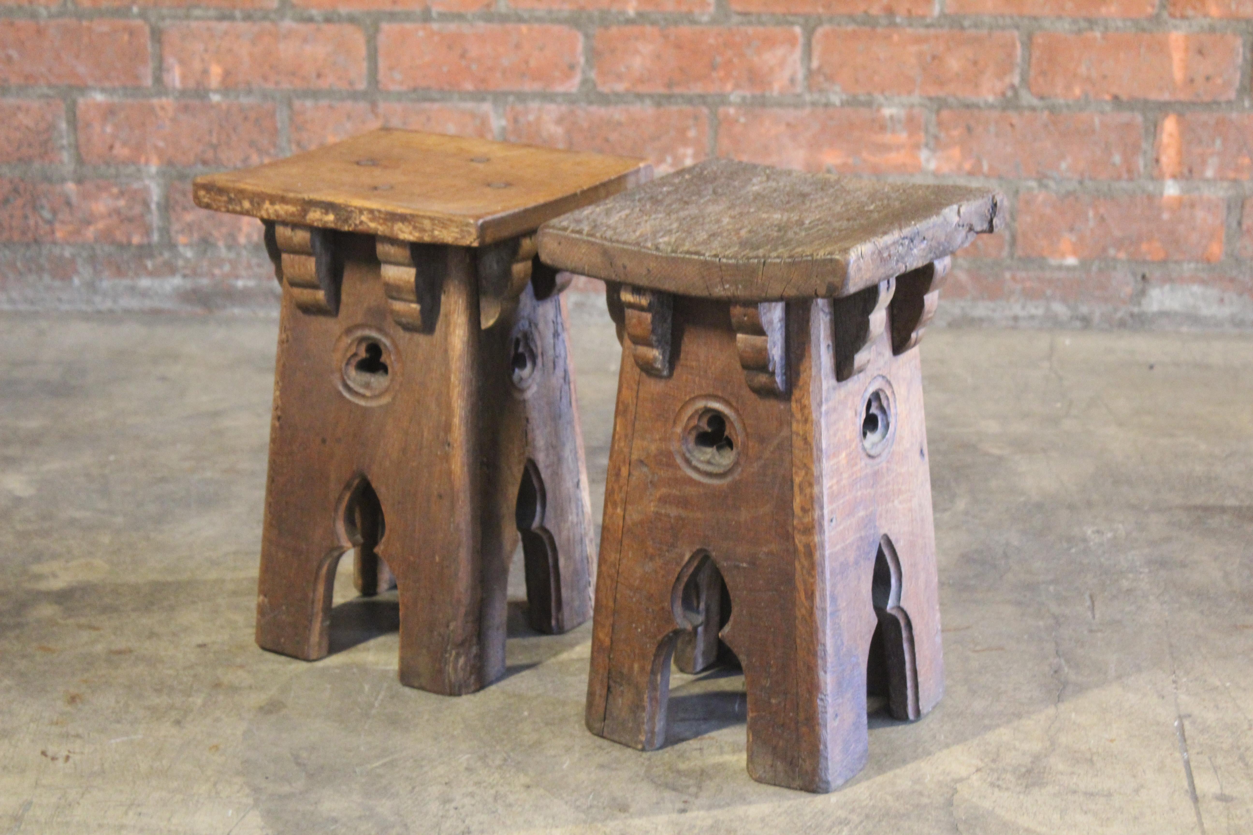 Pair of antique Gothic Revival French stools in oak. The pair are in good condition with signs of wear, appropriate with the age of the stools. Sold as a pair.