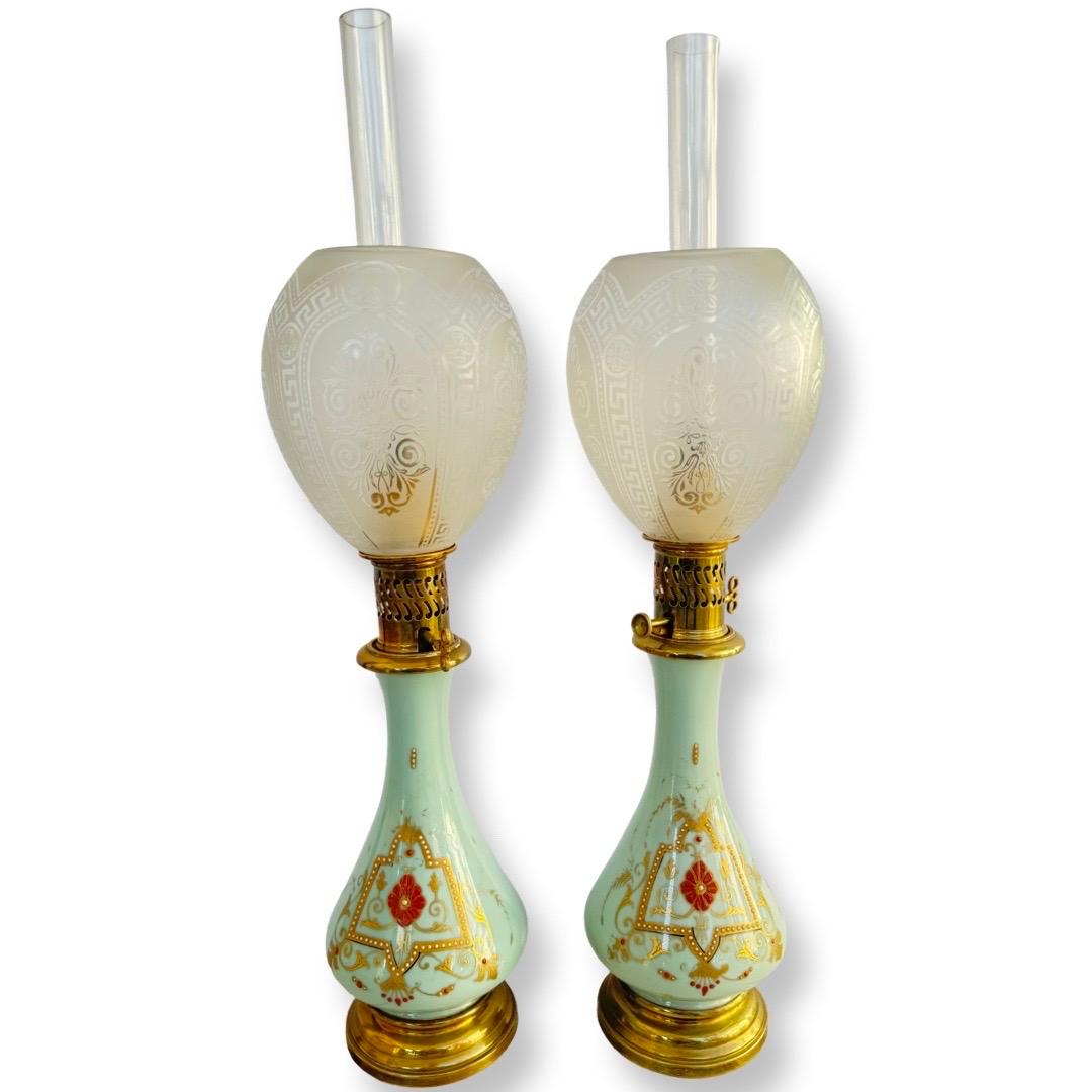 A pair of antique oil lamps with original Baccarat shades, height 62 cm.

This elegant pair of oil lamps features original shades crafted by the renowned French manufacturer Baccarat. The frosted glass shades are adorned with finely engraved