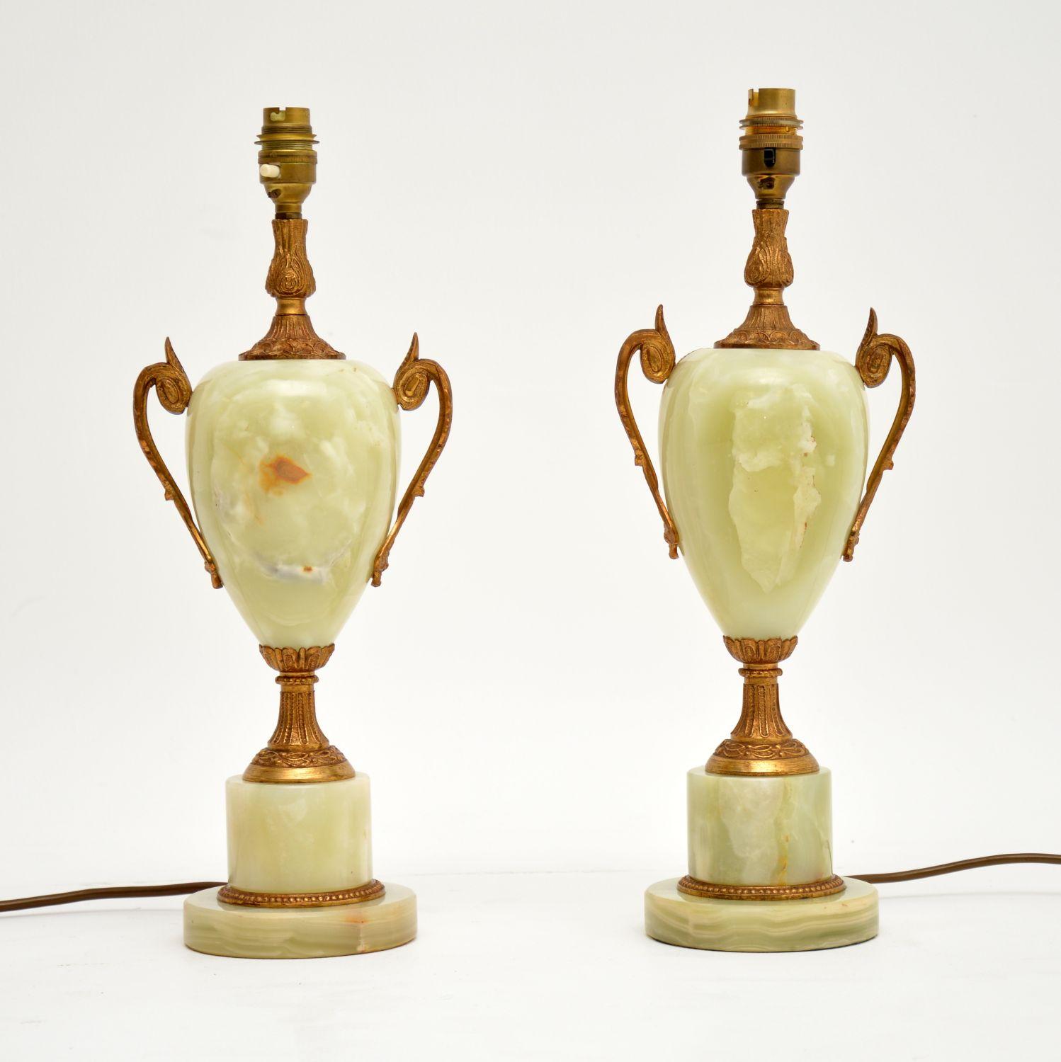 Pair of onyx and gilt metal table lamps in excellent working condition and dating roughly to circa 1950s period.

Measures: Width 7 inches, 17 cm
Depth 5 inches, 12 cm
Height 17 inches, 43 cm.