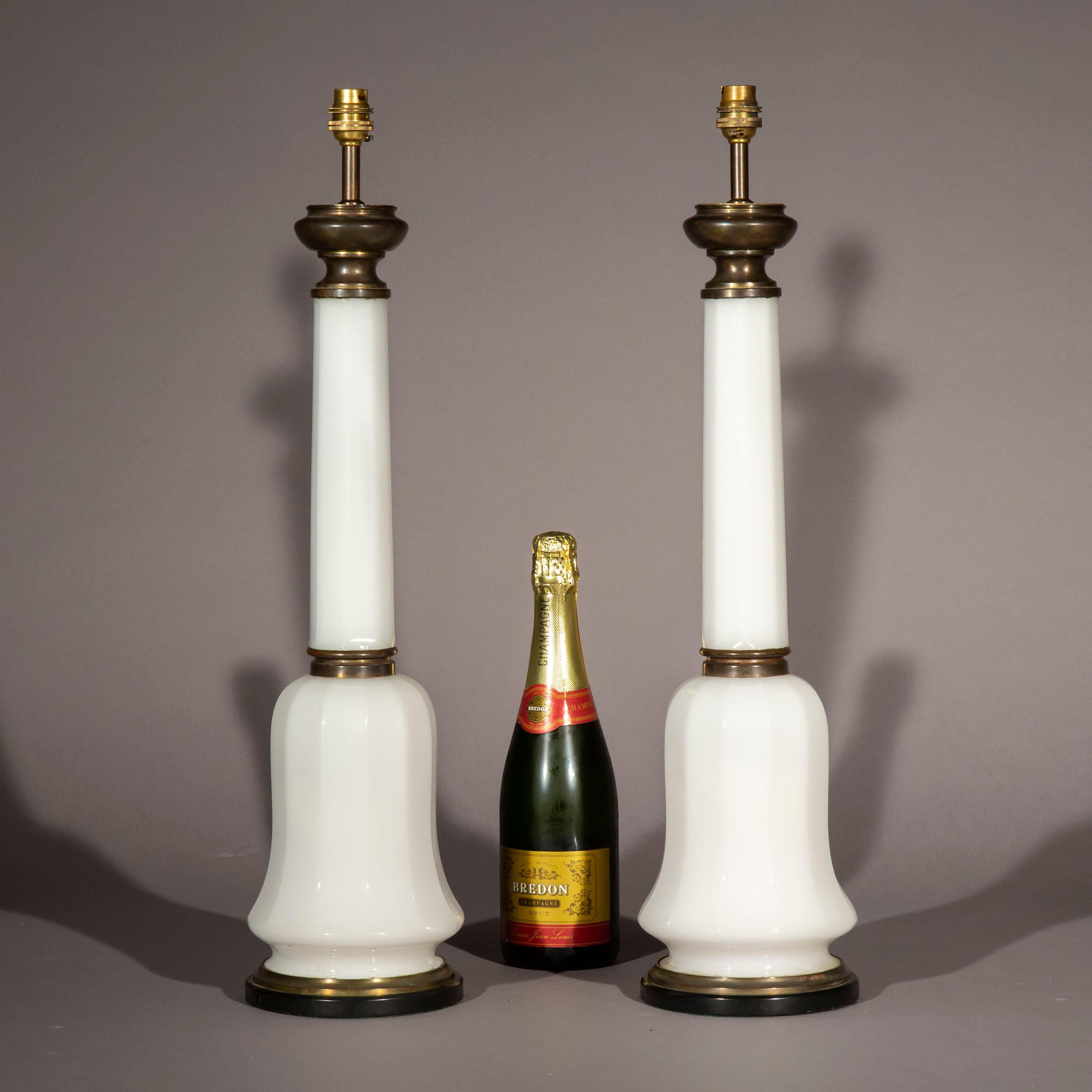 A handsome tall pair of white opaline glass and bronze table lamps, formerly Victorian oil lamps, now converted to electricity. Stand at 26.5 in / 67.5 cm tall.
Third quarter of the 19th century.

Why we like them
Their clean, timeless design,