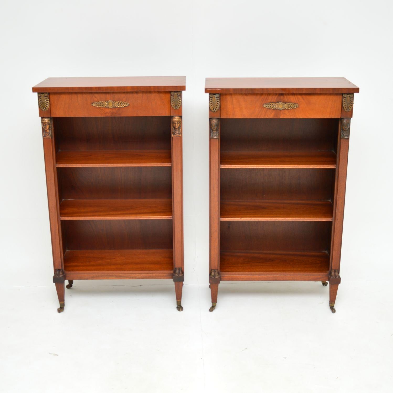 A beautiful and very well made pair of antique open bookcases. They are in the neo-classical style, and were made in England, around the 1950’s period.

The quality is superb and they are a very useful size. There are lovely ormolu mounts depicting