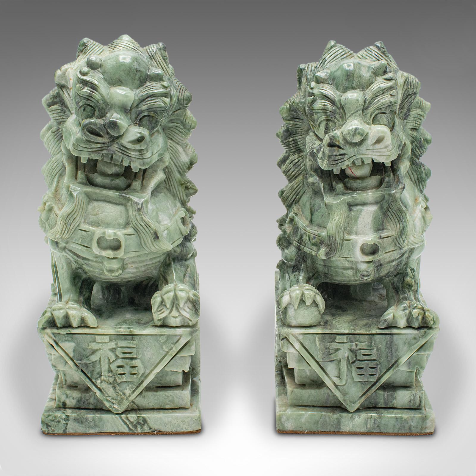 
This is a pair of antique Oriental bookends. A Chinese, jade marble decorative 'Dog of Fo' book rest, dating to the late Victorian period, circa 1900.

Delightfully tactile dogs with a superb natural finish and Oriental taste
Displaying a desirable