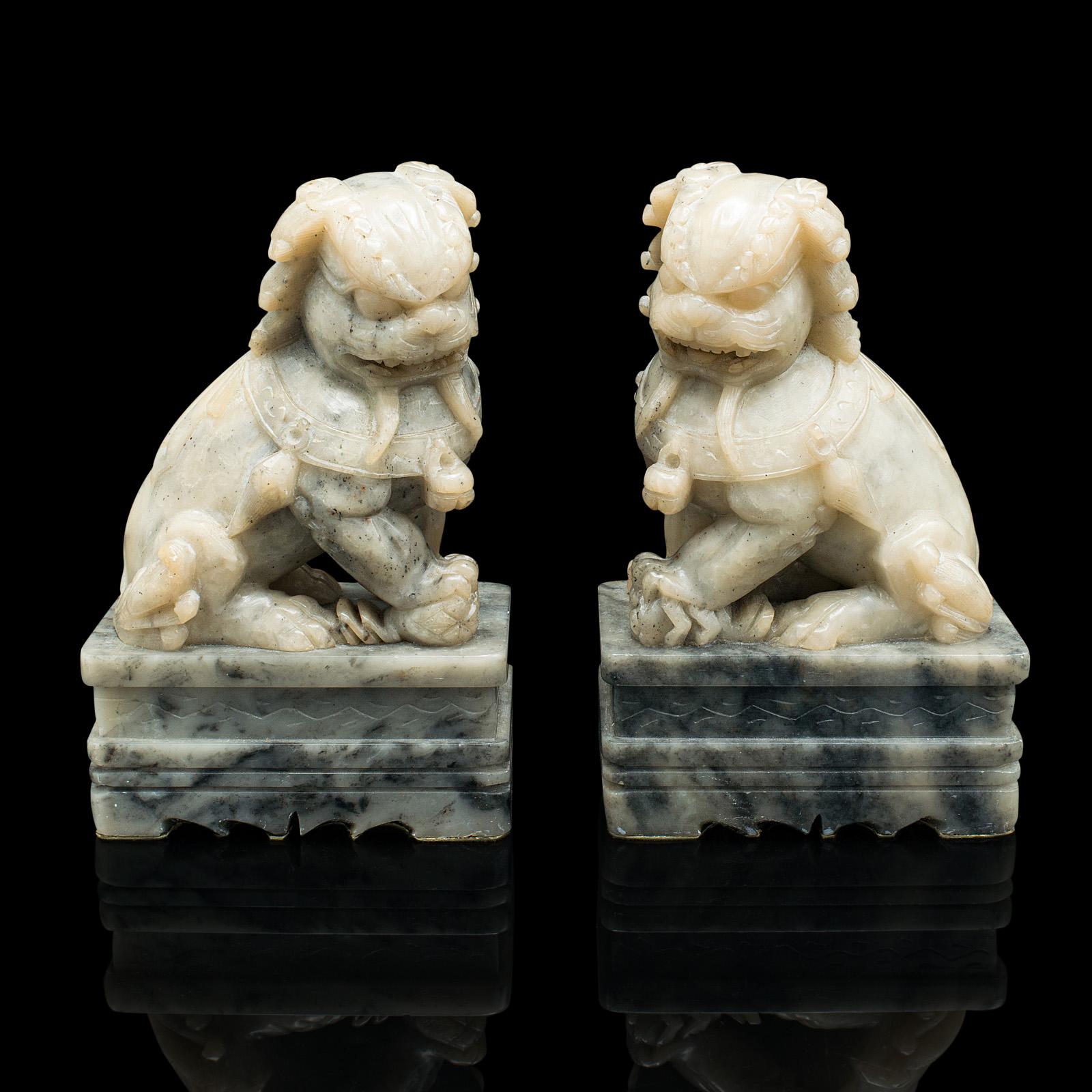 This is a pair of antique Oriental dog bookends. A Chinese, soapstone decorative 'Dog of Fo' book rest, dating to the late Victorian period, circa 1900.

Delightfully tactile dogs with a lovely natural finish and appearance
Displaying a desirable