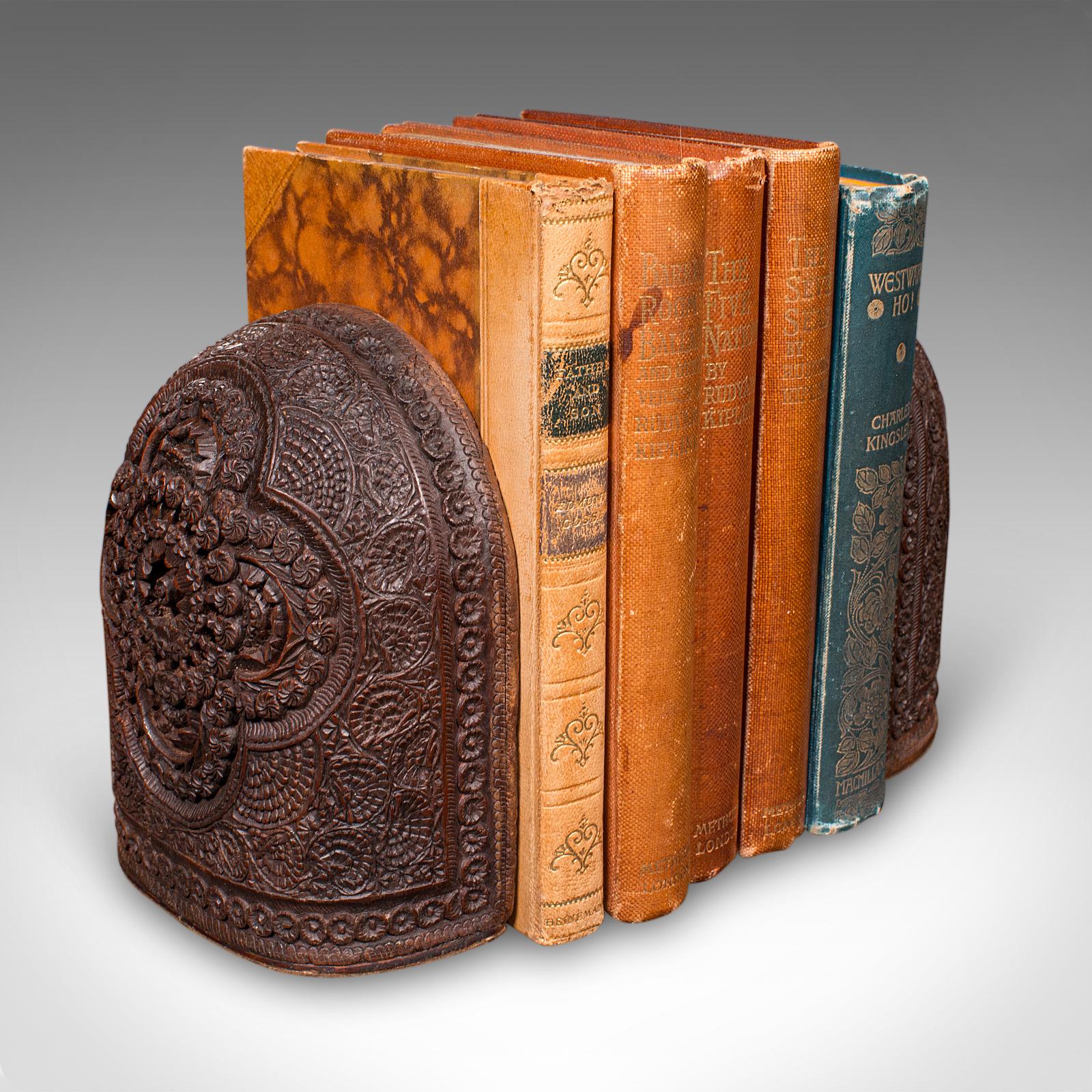 This is a pair of antique ornate bookends. An Anglo-Indian, carved beech book rest, dating to the late Victorian period, circa 1900. Displaying exceptional decorative appeal and fine craftsmanship, they make for a distinctive addition to the