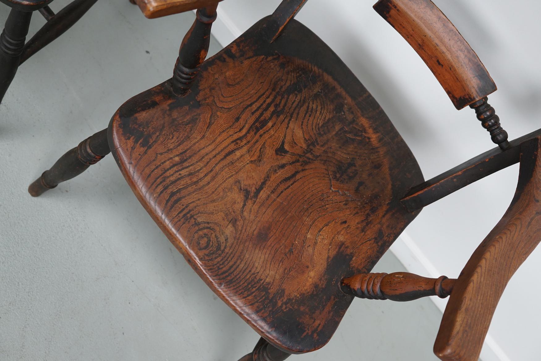 This pair of armchairs were made from Elm in the mid 19th century. They remain in a good antique condition with an amazing patina.