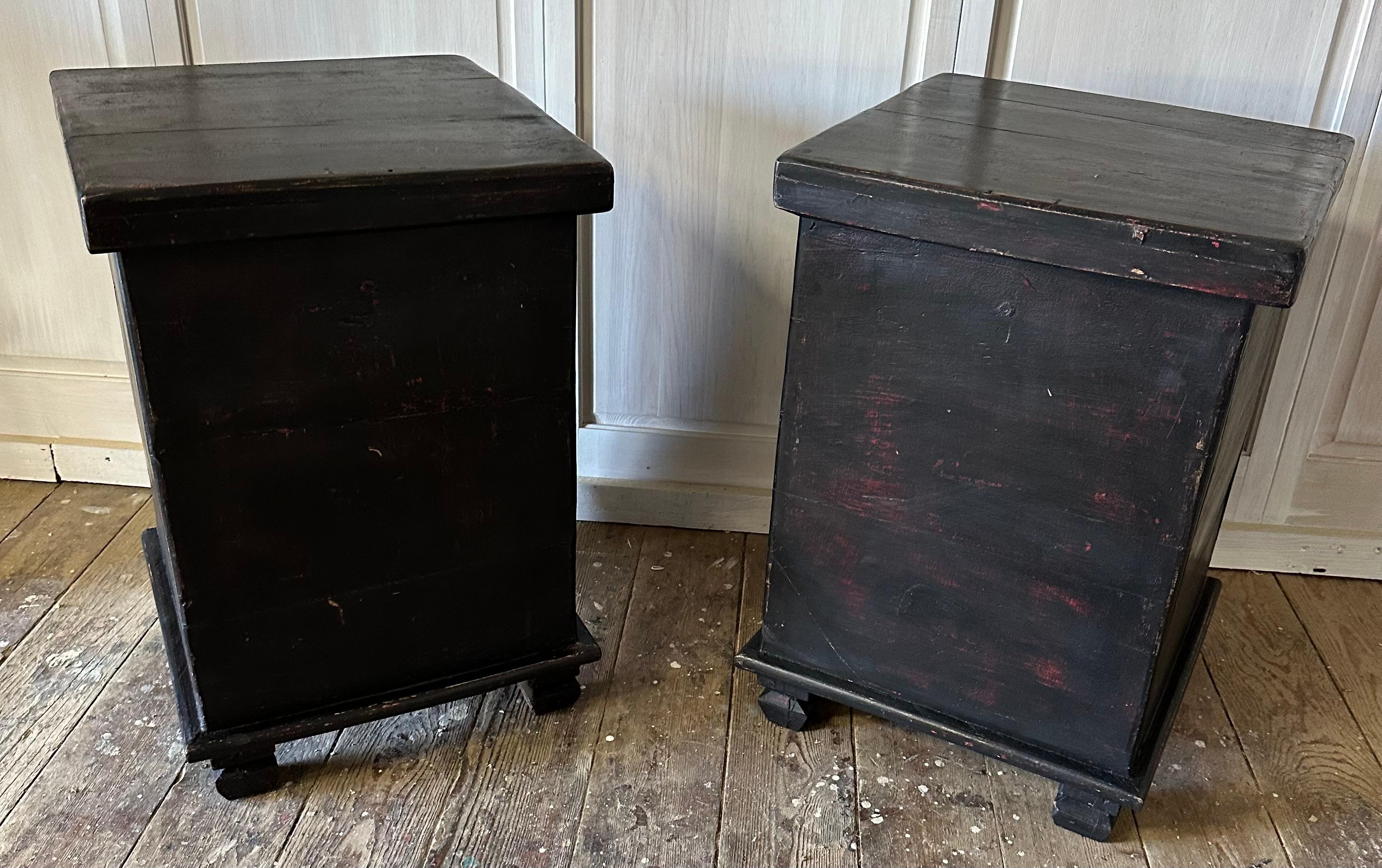 Pair of rustic black painted Chinese lidded blanket chests, great as side table, end table or night stand. The top lifts open fully allowing full use of interior storage. A protruding extension at the center back holds the lid up when open.
Search