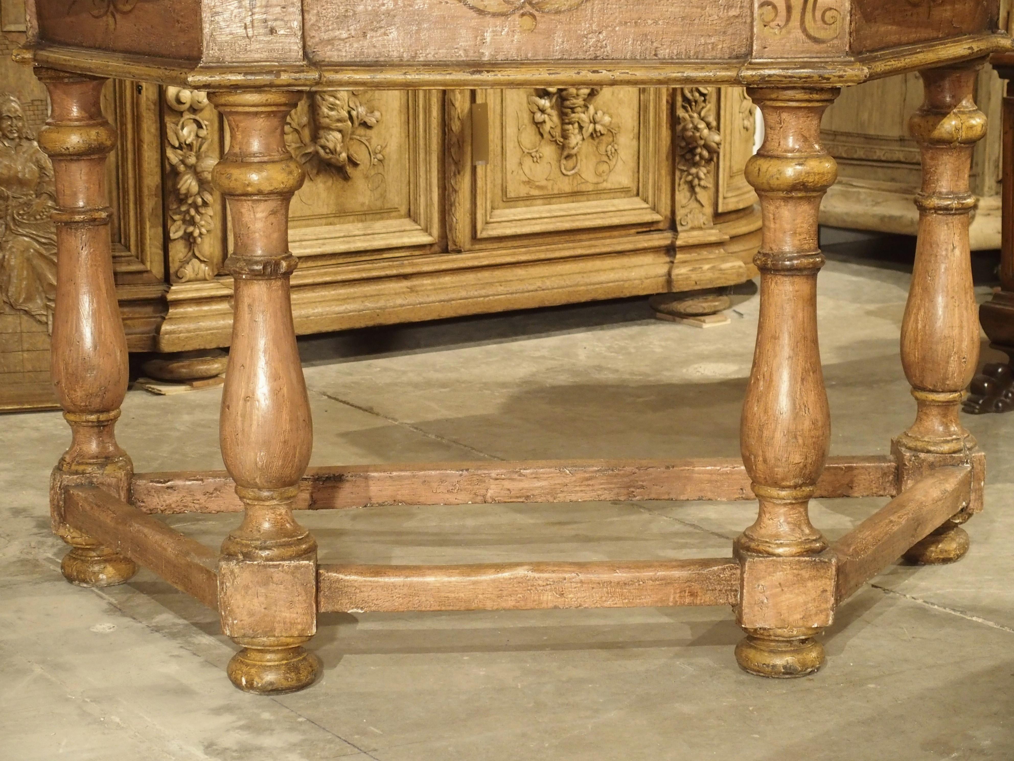 These beautiful antique Italian console tables are painted in an old rose and ochre/gold, and when pushed together, form a lovely octagonal center table. The consoles are relatively plain in their structure: well-considered moldings, no drawers in