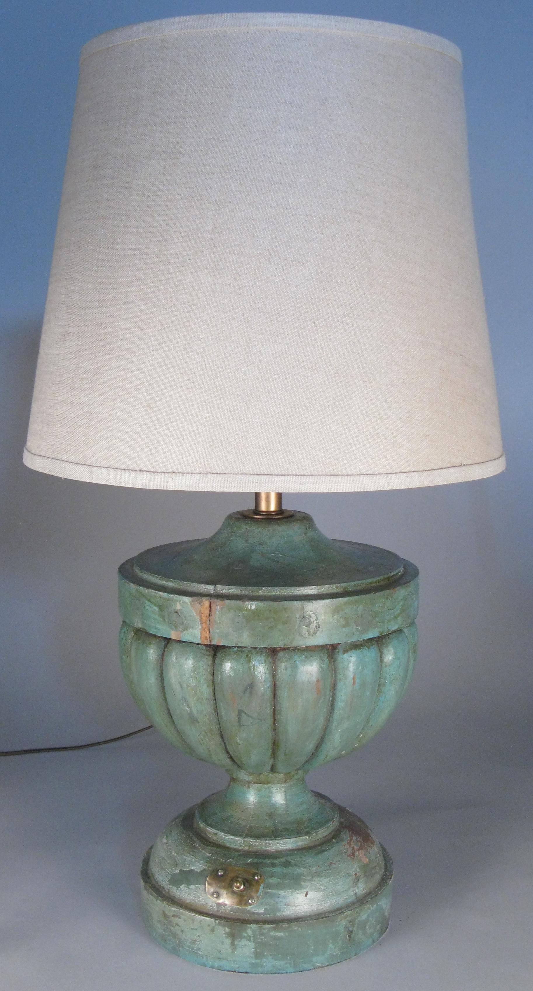 a beautiful pair of antique 1940s table lamps with painted wood bases in a carved urn shape. the bases have the remains of the original hunter green painted finish. completely rewired with double sockets with brass pull chains. the original brass