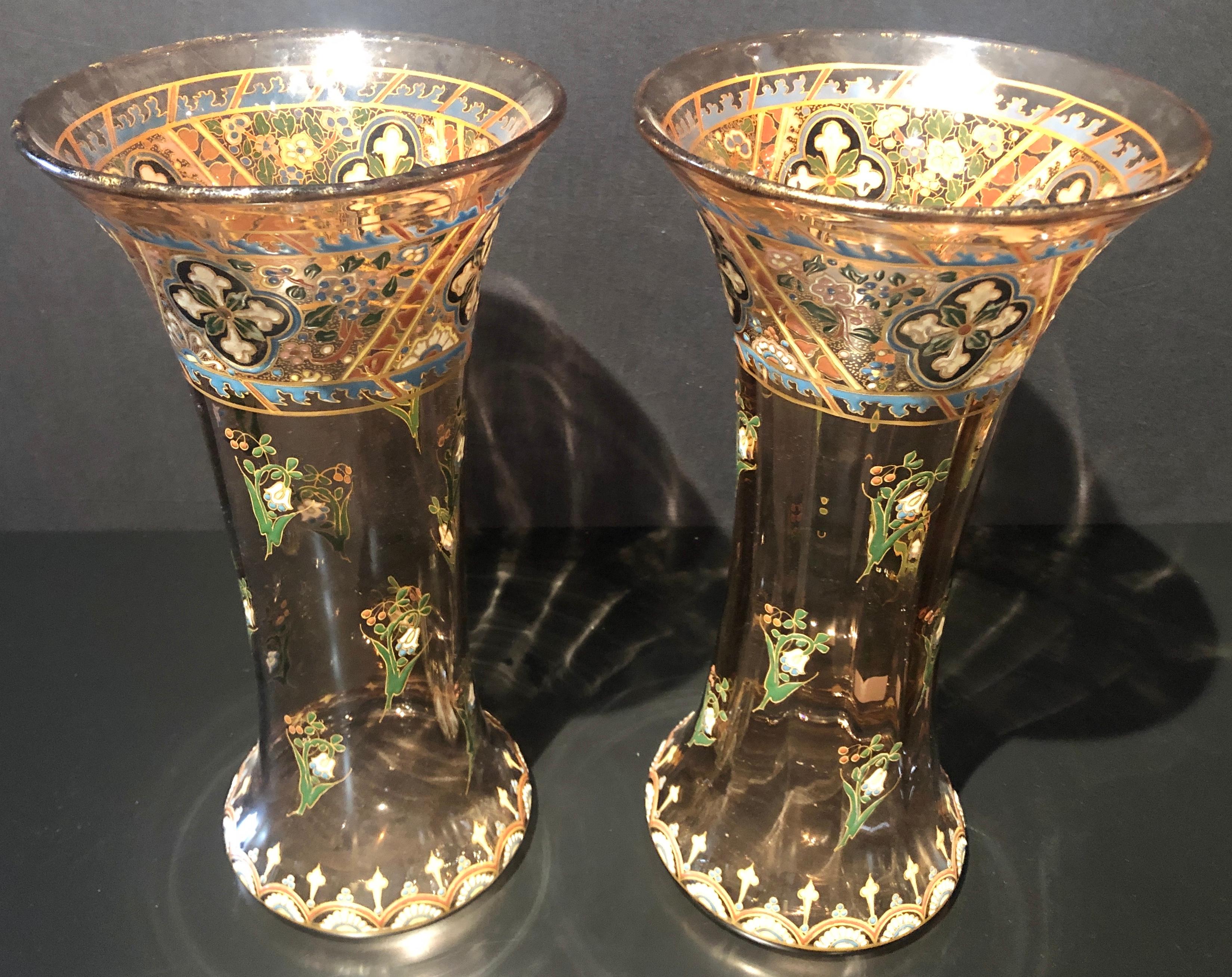Pair of Emile Galle style antique Palatial French jeweled vases. Simply the finest floral vases one could possibly hope to fine. The overall amber glass having jeweled work depicting colorful raised floral and decorative design. Unsigned.