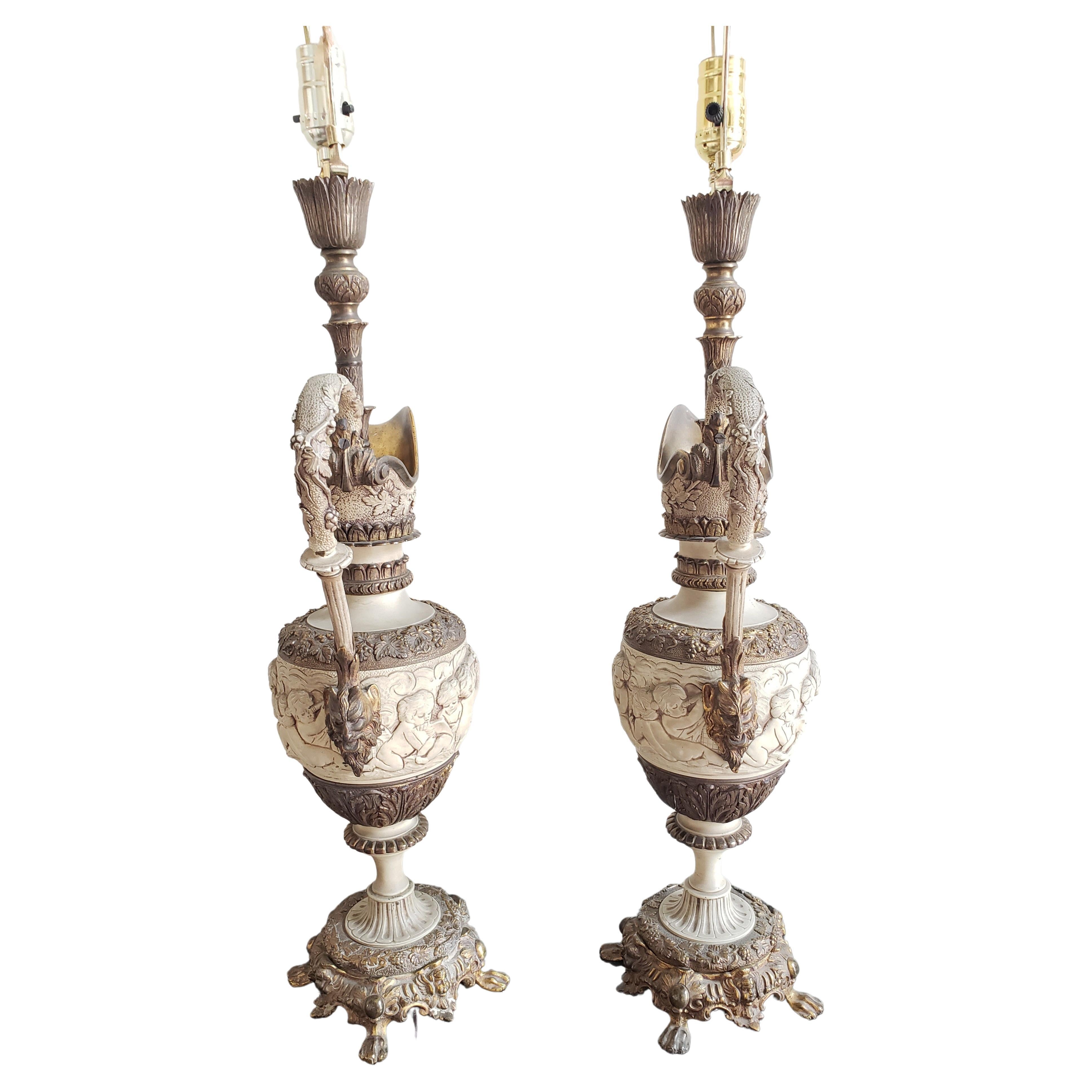 Pair of heavy bronze partial gilt table lamps in the form of ewers with paw feet, profusely worked. Richly bronze carving with cherubs throughout. Late 19th century in good vintage condition.
Measures 10.25