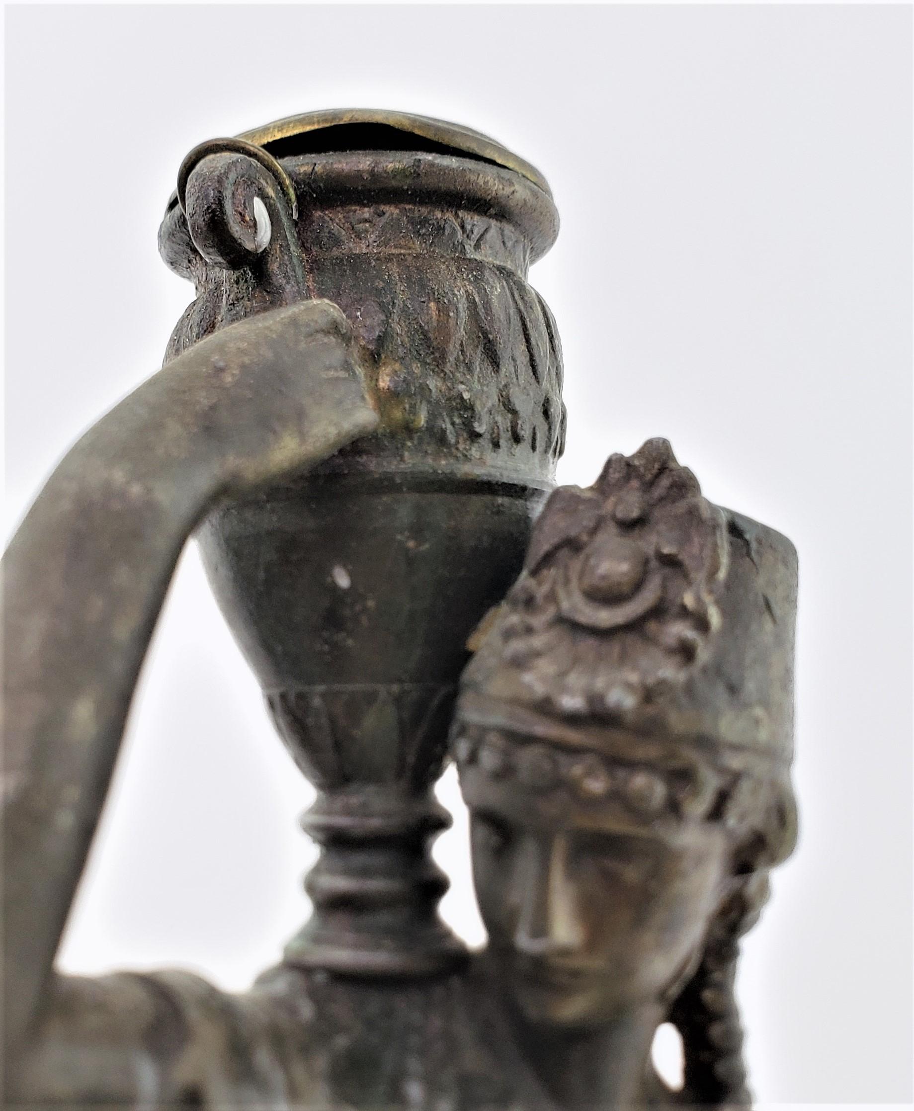 Coppia di antichi candelabri in spelta patinata raffiguranti un uomo e una donna che trasportano acqua in vendita 5