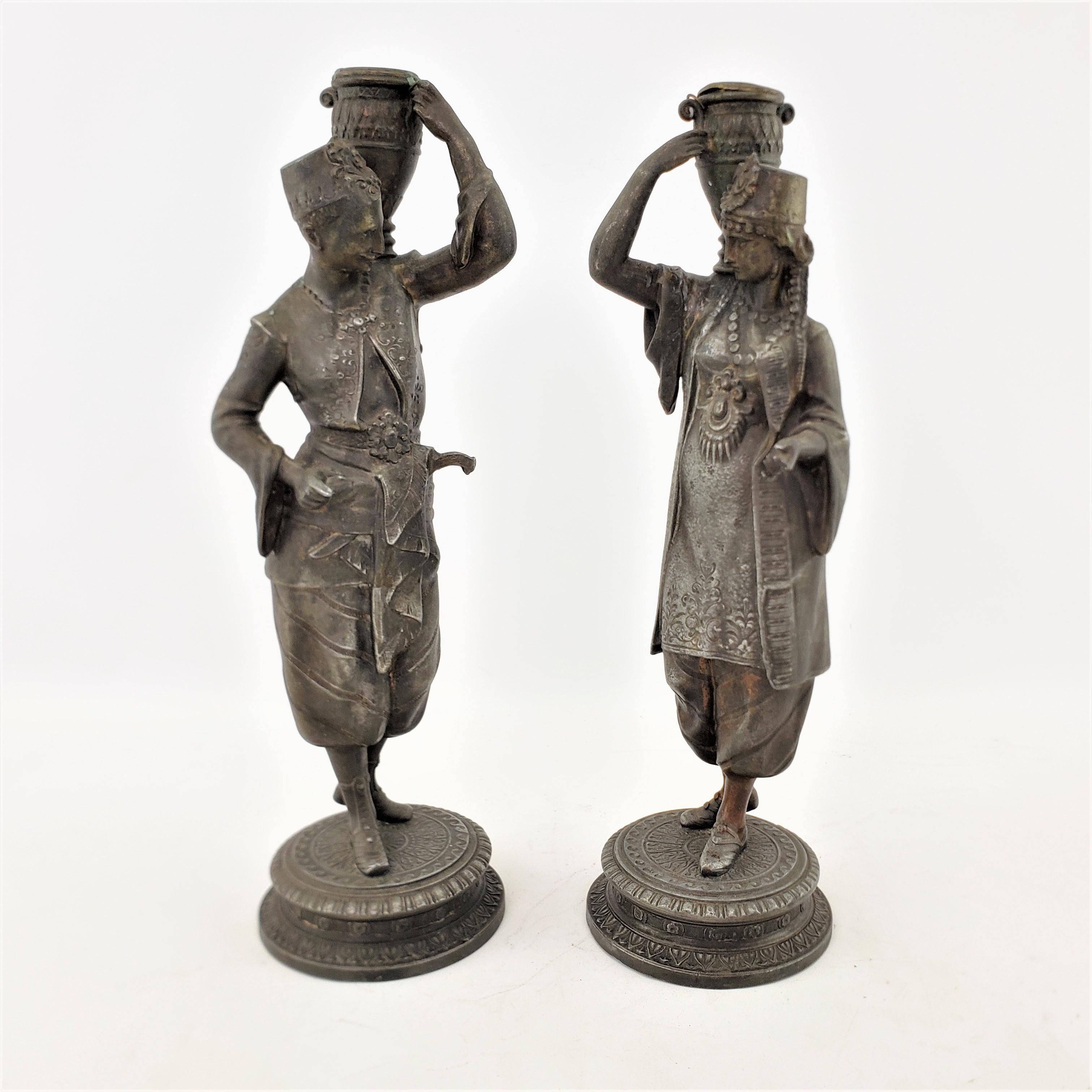 Neoclassical Revival Pair of Antique Patinated Spelter Candlesticks of a Man & Woman Carrying Water For Sale