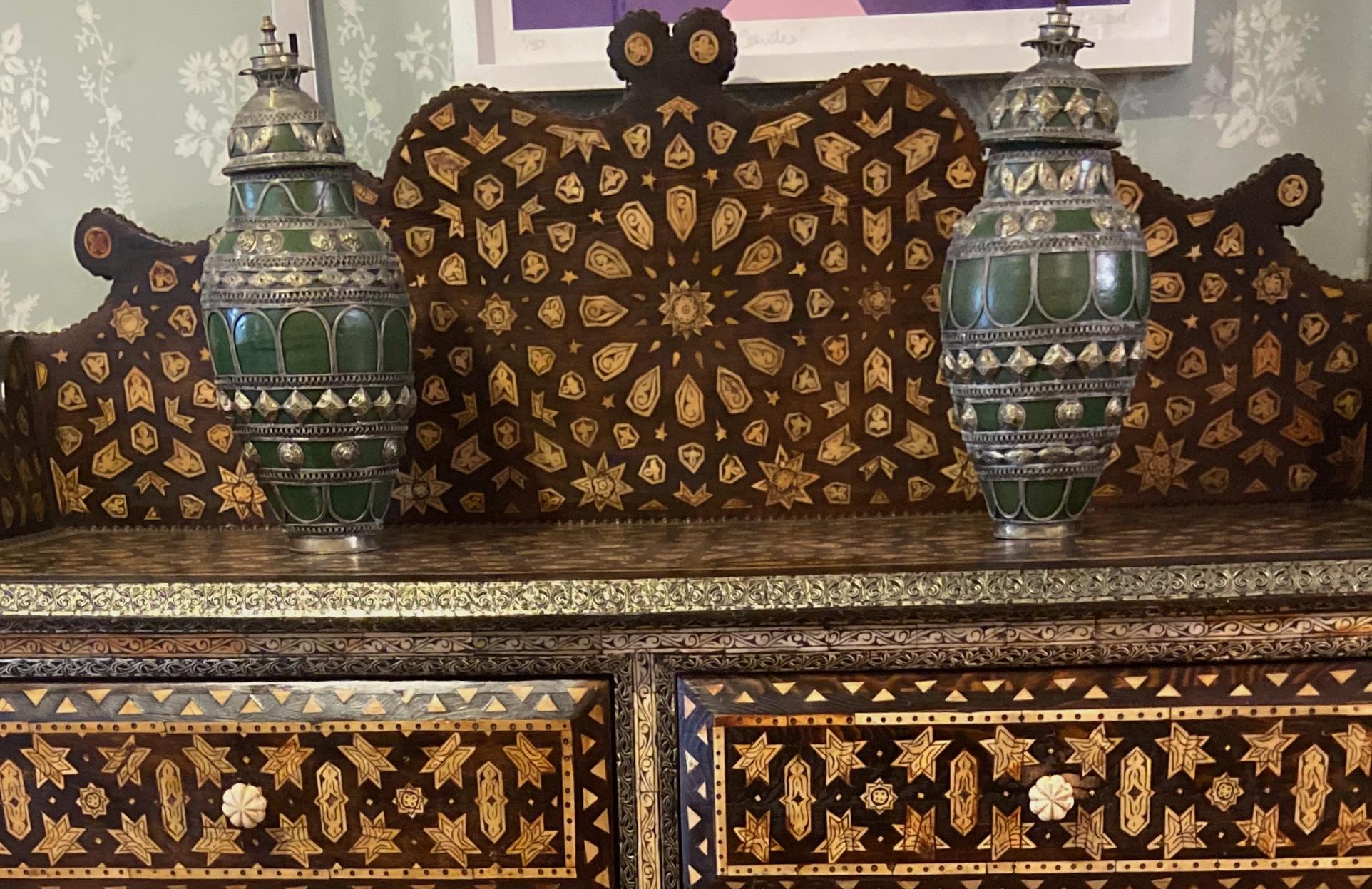 A beautiful pair of antique Persian white metal mounted green glazed pottery vases with covers. 

These unusual early 20th century vases are of baluster form with geometric bands.


Measures: 45 cm high.