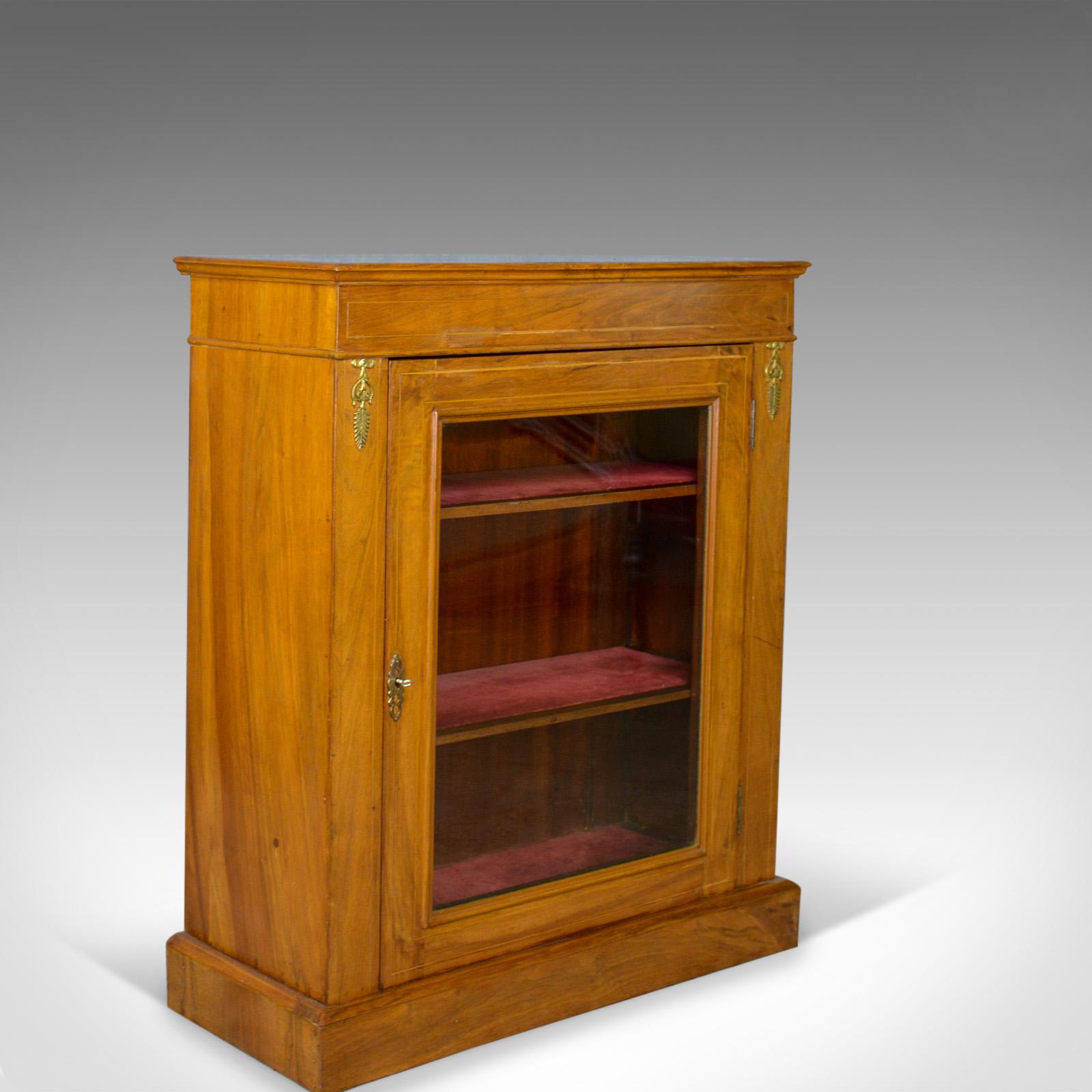 This is a pair of antique pier cabinets, English, Walnut, Edwardian, Regency Revival display cabinets dating to the early 20th century, circa 1910.

Attractive honey hues to the select English walnut
Well figured grain interest in a wax polished