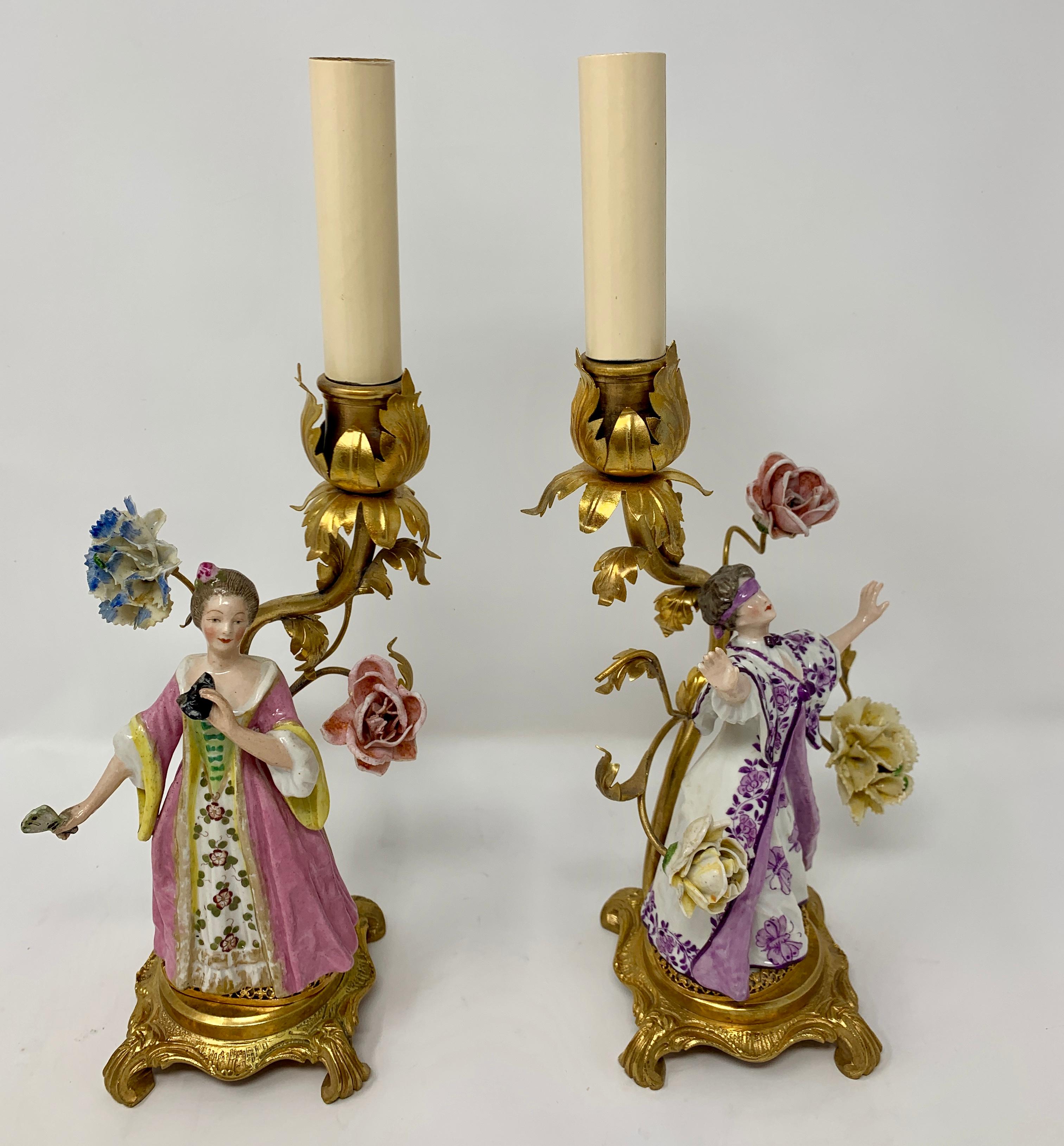 Pair of antique delicate porcelain figurine candlesticks with flowers. Charming and very lovely.