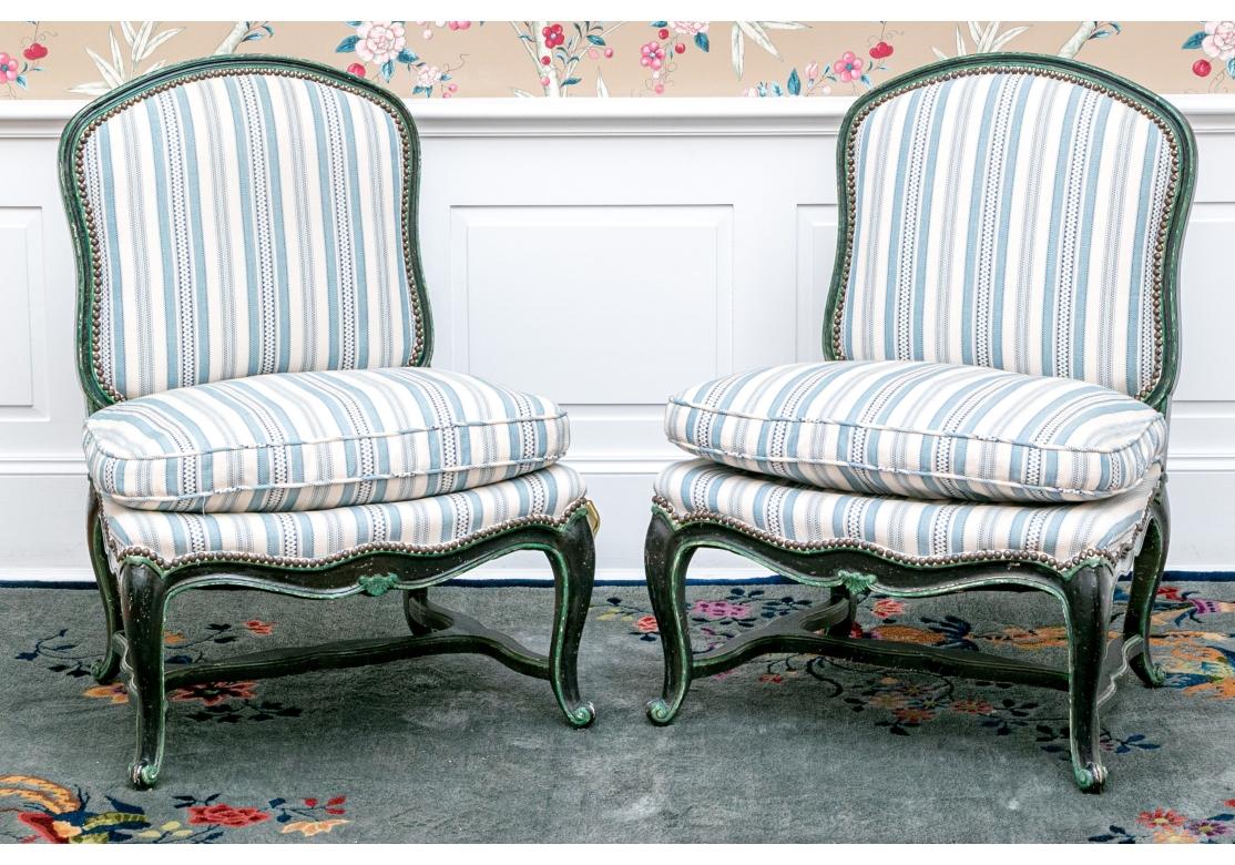 A fine pair of Custom upholstered Slipper Chairs having a Blue and White Stripe fabric with nail head trim. The black and green painted frames with Cabriole legs, shaped Stretcher and Snail’s Head foot.  Very solid feeling and comfortable.