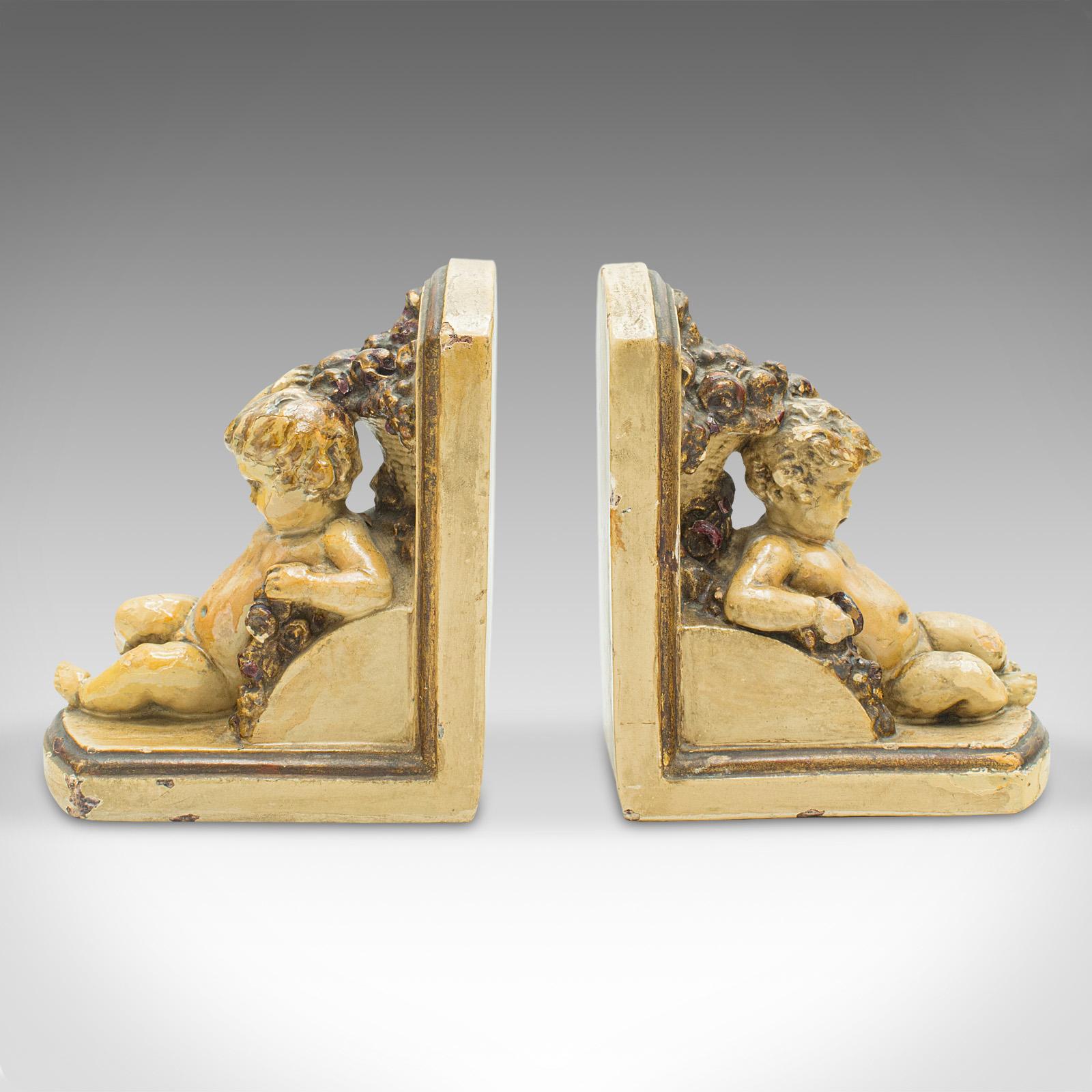 This is a pair of antique putto bookends. An Italian, plaster decorative cherub book rest in Grand Tour taste, dating to the early Victorian period, circa 1850.

Charming cherubic figures lounge against these distinctive bookends
Displaying a
