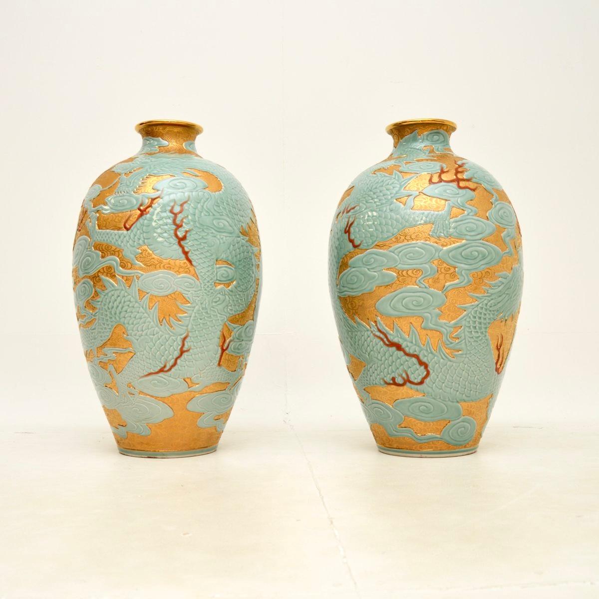A very large and impressive pair of antique Qianlong style Chinese ceramic vases, dating from around the mid twentieth century.

They are of amazing quality and are beautifully decorated with a duck egg blue, gold and red tones. They depict swirling