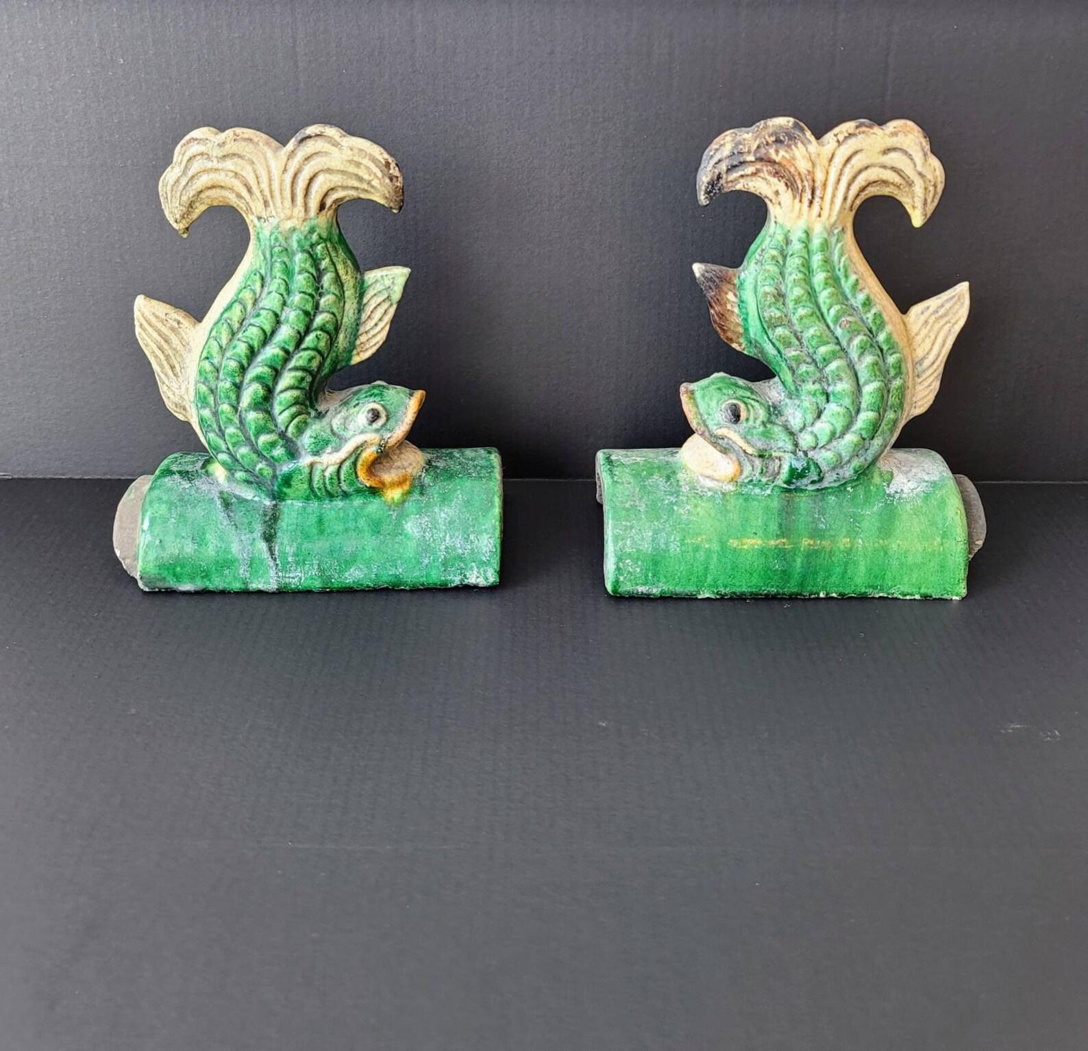 A pair of Qing dynasty (1636–1912) Sancai glazed ceramic figural roof tiles with rich beautifully aged patina!

Dating to the 19th century, wonderfully hand-crafted and painted, sculptural form depicting stylized fish, rising on terracotta clay