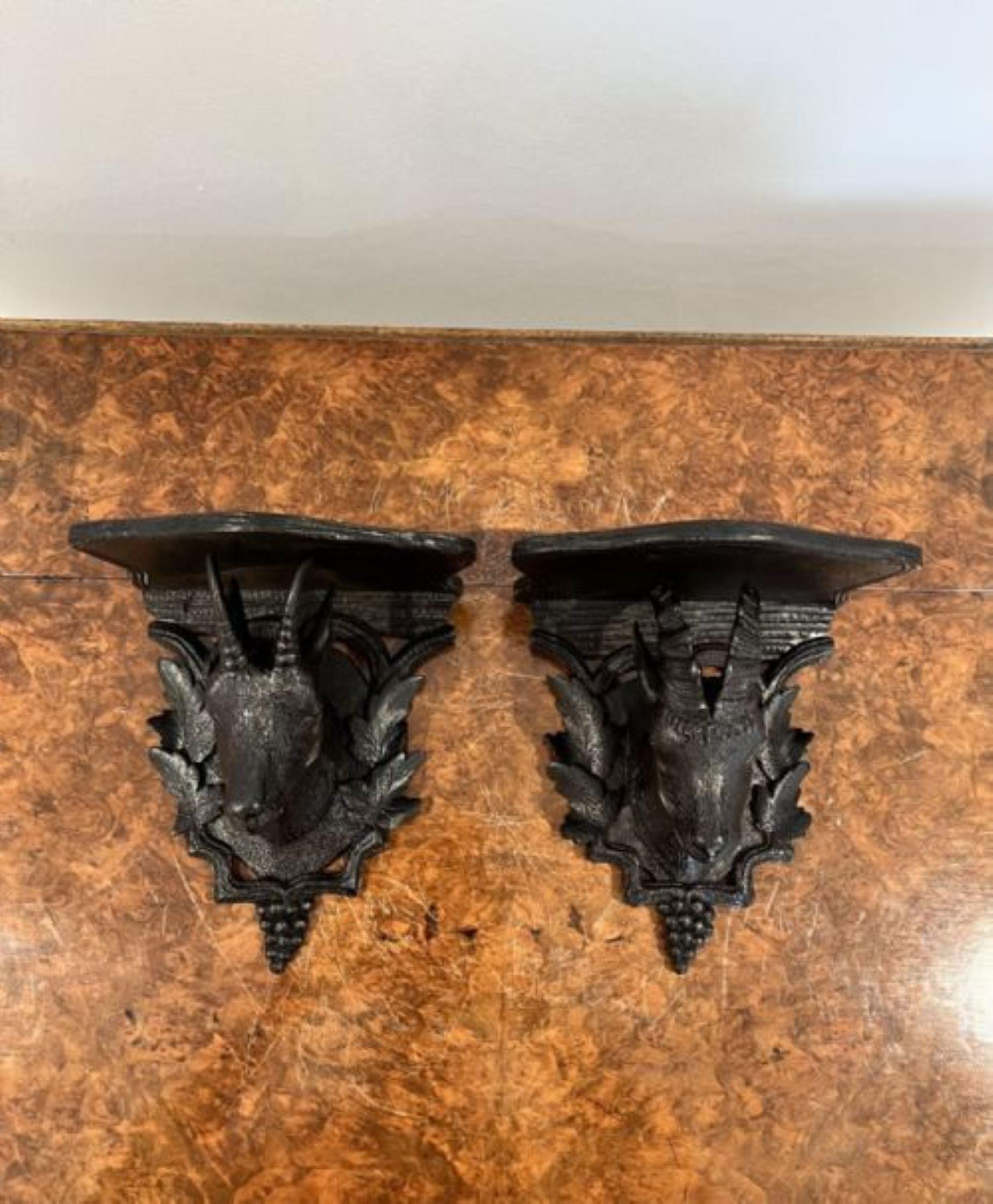 Pair of antique quality Black Forest carved wall brackets having a male and female carved goats with a shaped carved back and top