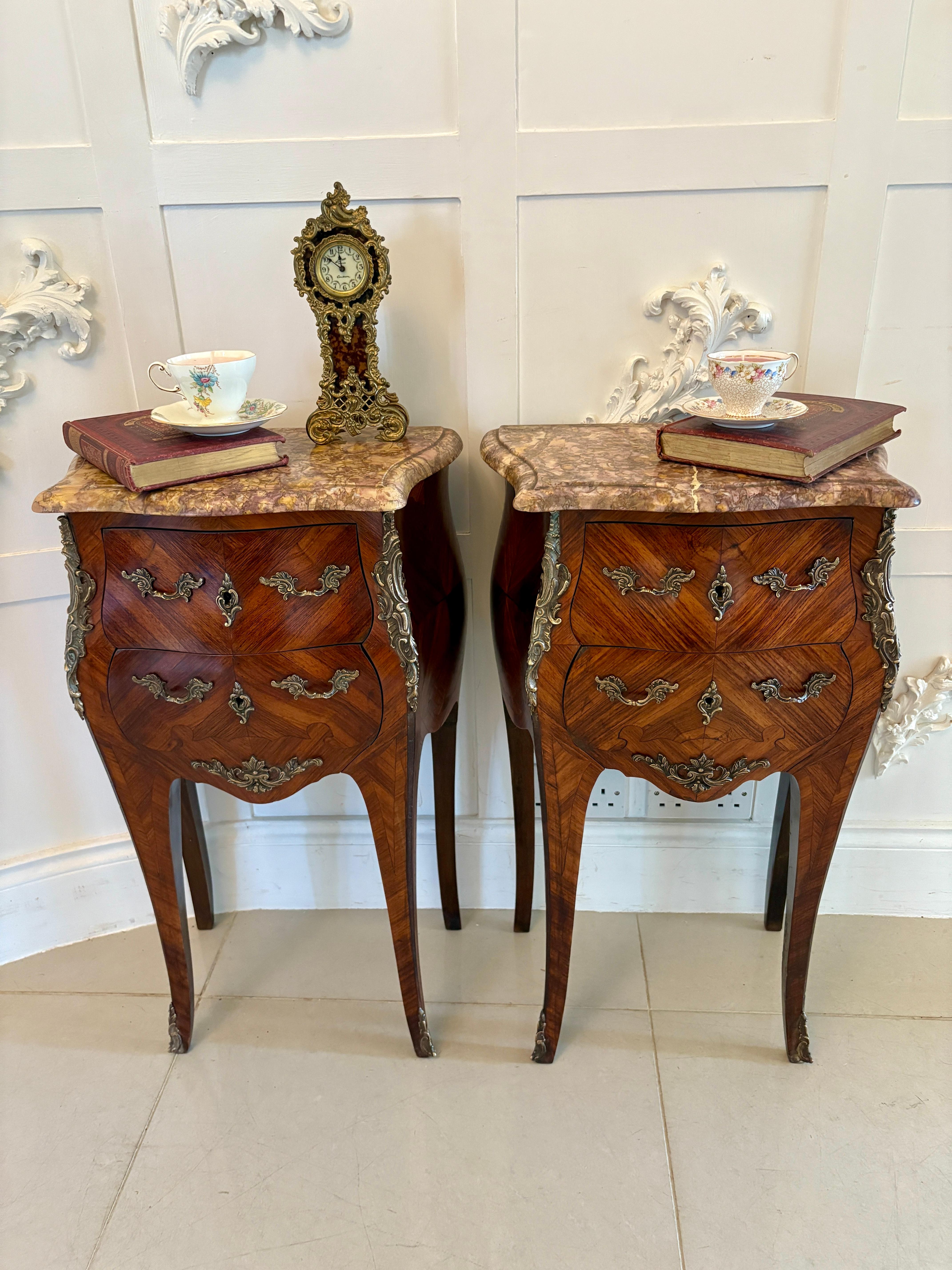 Pair of antique quality French kingwood marble top marquetry inlaid bedside cabinets having quality serpentine shaped marble tops with a thumb moulded edge above two bombe shaped kingwood marquetry inlaid drawers with original ornate brass handles,